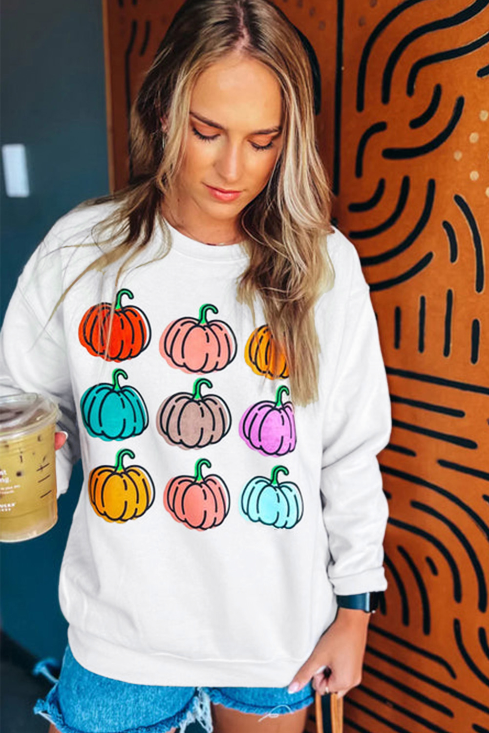 Elevate your fall wardrobe with this Women's Beige Vibrant Pumpkins Print Crew Neck Halloween Sweatshirt. The playful design and lively pumpkin patterns make it a perfect choice for the fall season. The timeless crew neck and dropped shoulders provide a comfortable and classic fit. Made from a blend of 50% polyester and 50% cotton, this sweatshirt ensures both durability and softness. The vibrant pumpkin patterns are ideal for Halloween or autumnal outings, adding a touch of whimsy to your look. Pair it with jeans or casual pants for a complete outfit that's ready to enjoy the season. The long sleeves and cozy fabric keep you snug during cooler weather, making it a versatile and stylish addition to your wardrobe. - Detail View 4 Elevate your fall wardrobe with this Women's Beige Vibrant Pumpkins Print Crew Neck Halloween Sweatshirt. The playful design and lively pumpkin patterns make it a perfect choice for the fall season. The timeless crew neck and dropped shoulders provide a comfortable and classic fit. Made from a blend of 50% polyester and 50% cotton, this sweatshirt ensures both durability and softness. The vibrant pumpkin patterns are ideal for Halloween or autumnal outings, adding a touch of whimsy to your look. Pair it with jeans or casual pants for a complete outfit that's ready to enjoy the season. The long sleeves and cozy fabric keep you snug during cooler weather, making it a versatile and stylish addition to your wardrobe. - Detail View 4