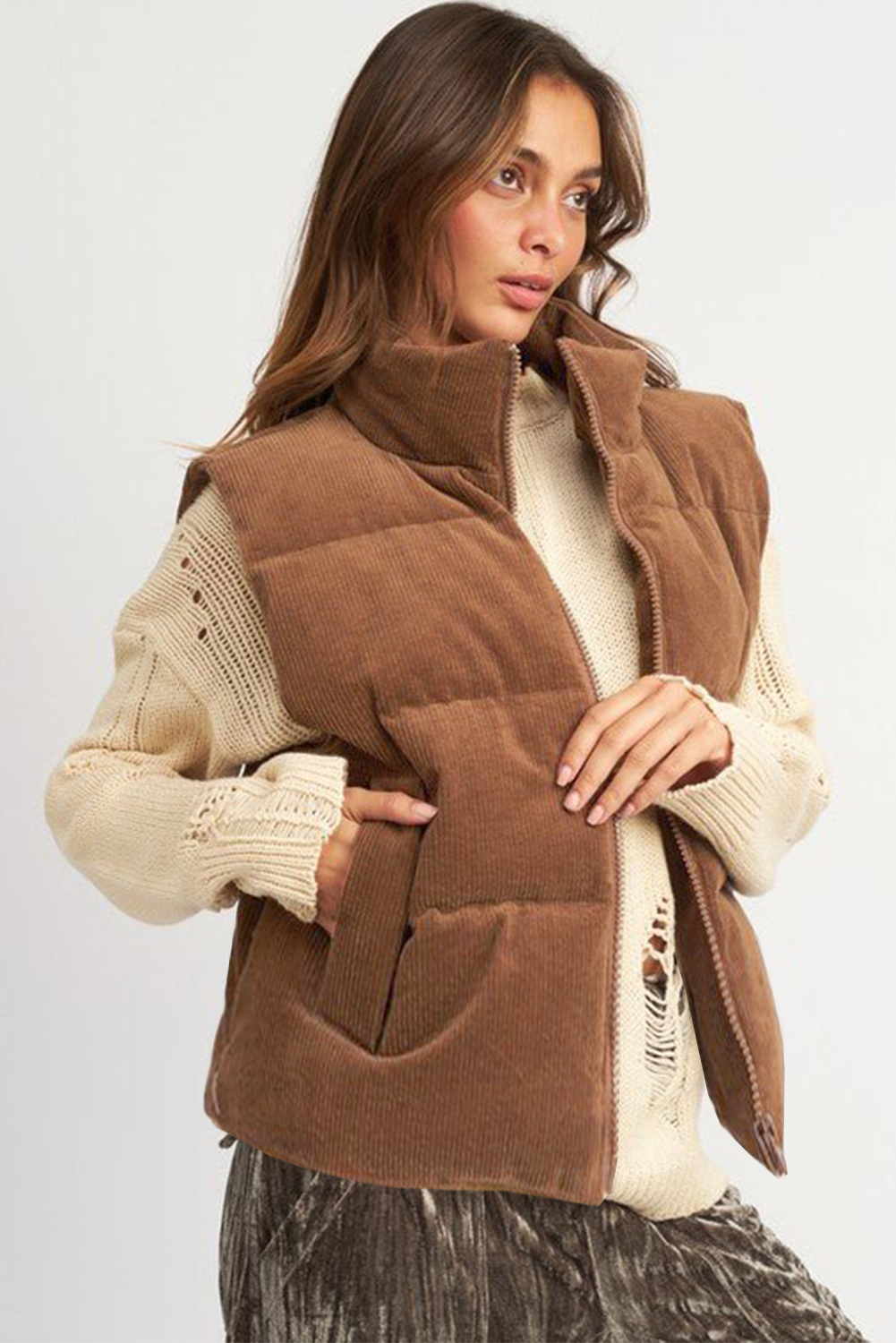 Stay warm and stylish with this Women's Coffee Corduroy Stand Neck Zip Puffer Vest. The stand neck design adds a touch of elegance and sophistication, while the puffer style provides added insulation and a fashion-forward statement. The zipper closure makes it easy to wear and offers a sleek look. This vest is made from 100% polyester and features a solid coffee color, making it perfect for daily wear in the winter season. Pair it with your favorite dress or top and jeans for a chic and cozy outfit. With this vest, you can effortlessly elevate your personal style and stay warm and comfortable all day long. - Detail View 4 Stay warm and stylish with this Women's Coffee Corduroy Stand Neck Zip Puffer Vest. The stand neck design adds a touch of elegance and sophistication, while the puffer style provides added insulation and a fashion-forward statement. The zipper closure makes it easy to wear and offers a sleek look. This vest is made from 100% polyester and features a solid coffee color, making it perfect for daily wear in the winter season. Pair it with your favorite dress or top and jeans for a chic and cozy outfit. With this vest, you can effortlessly elevate your personal style and stay warm and comfortable all day long. - Detail View 4