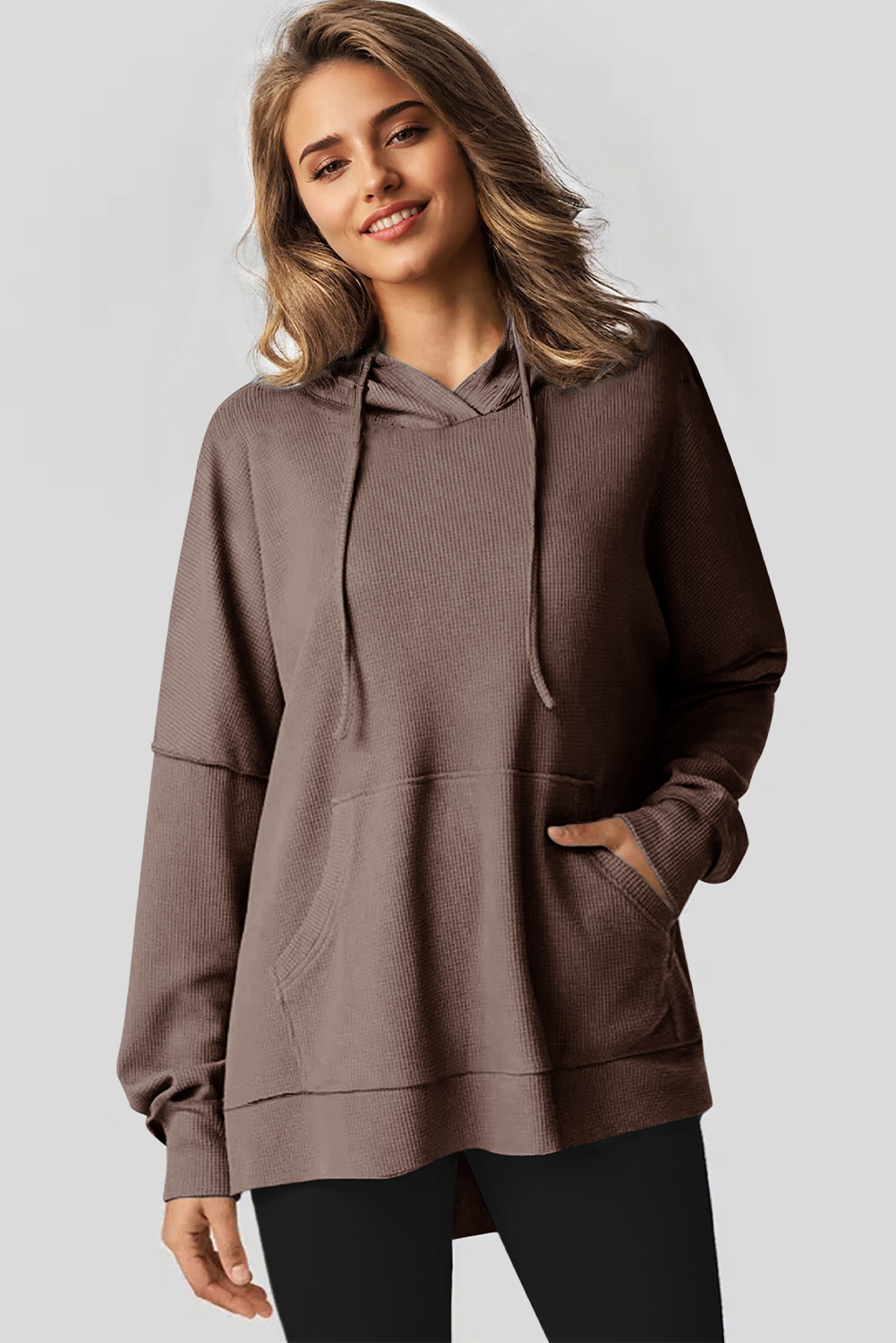 Stay warm and stylish in the colder months with this Women's Coffee Waffle Knit Fleece Lined High Low Oversized Hoodie. The soft jacquard knit fabric creates a cozy feel, while the outstanding fleece-lined design provides warmth and comfort. The stylish high low design and oversized fit enhance a casual and slender silhouette, making it a fashionable and comfortable choice for fall and winter. The convenient kangaroo pocket not only adds a decorative element but also provides storage for your essentials. Made from a premium blend of 75% polyester and 25% cotton, this hoodie ensures durability and breathability. The versatile design makes it perfect for daily wear, offering both style and comfort. Stay cozy and chic with this must-have coffee-colored hoodie. - Detail View 4 Stay warm and stylish in the colder months with this Women's Coffee Waffle Knit Fleece Lined High Low Oversized Hoodie. The soft jacquard knit fabric creates a cozy feel, while the outstanding fleece-lined design provides warmth and comfort. The stylish high low design and oversized fit enhance a casual and slender silhouette, making it a fashionable and comfortable choice for fall and winter. The convenient kangaroo pocket not only adds a decorative element but also provides storage for your essentials. Made from a premium blend of 75% polyester and 25% cotton, this hoodie ensures durability and breathability. The versatile design makes it perfect for daily wear, offering both style and comfort. Stay cozy and chic with this must-have coffee-colored hoodie. - Detail View 4