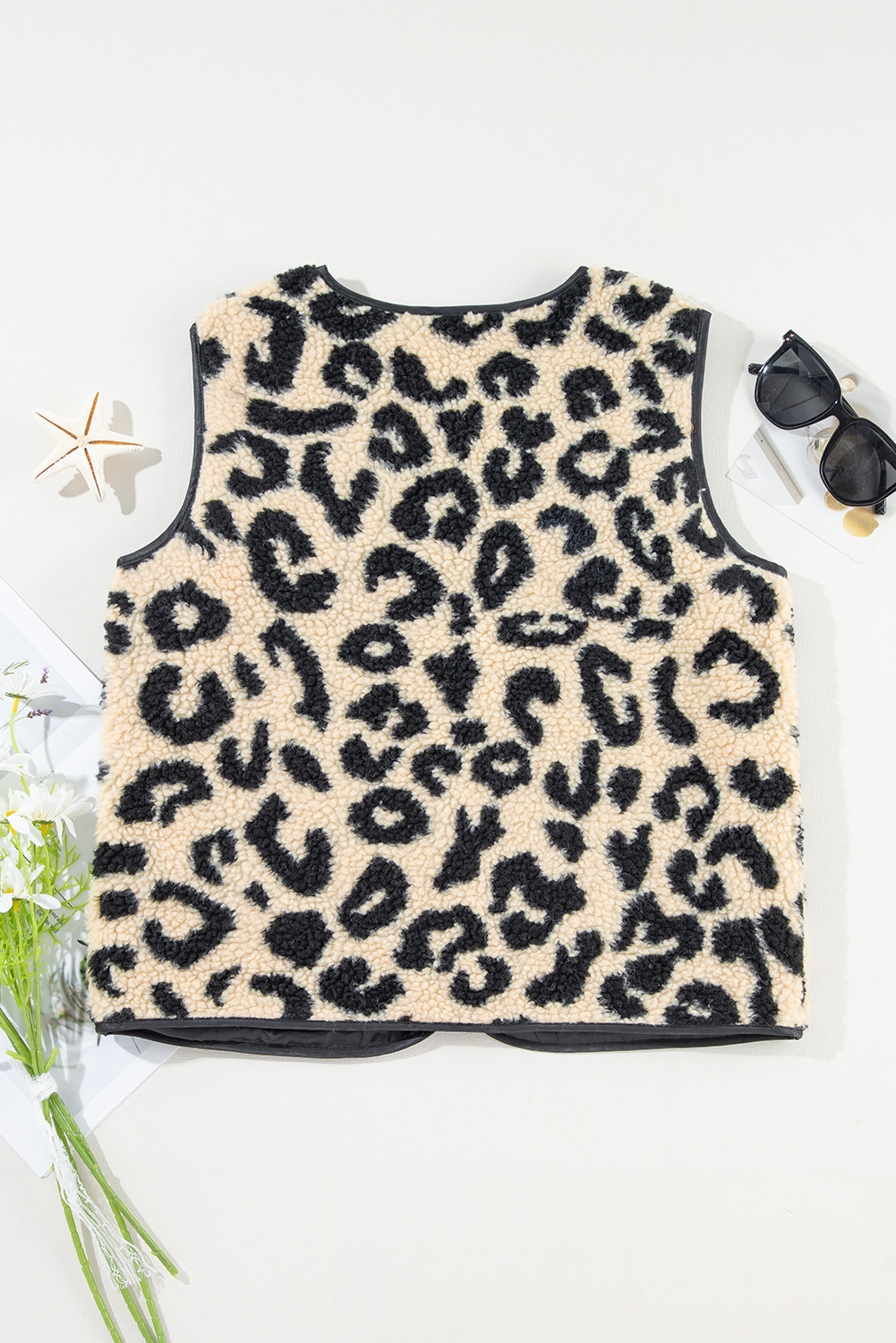 Elevate your outfit and embrace your wild side with this Women's Black Leopard Print Sherpa Vest Coat. The striking leopard print adds a bold and fashionable touch to your look, while the plush sherpa material ensures optimal warmth and comfort during the winter season. The versatile open front design allows for easy layering and adds a stylish element to any outfit. This sleeveless vest coat is perfect for adding a statement to your daily ensembles, offering both style and functionality. Made from premium 100% polyester, this vest coat is durable and easy to maintain. Embrace the casual and Western-inspired style with this chic and cozy addition to your winter wardrobe. - Detail View 19 Elevate your outfit and embrace your wild side with this Women's Black Leopard Print Sherpa Vest Coat. The striking leopard print adds a bold and fashionable touch to your look, while the plush sherpa material ensures optimal warmth and comfort during the winter season. The versatile open front design allows for easy layering and adds a stylish element to any outfit. This sleeveless vest coat is perfect for adding a statement to your daily ensembles, offering both style and functionality. Made from premium 100% polyester, this vest coat is durable and easy to maintain. Embrace the casual and Western-inspired style with this chic and cozy addition to your winter wardrobe. - Detail View 19