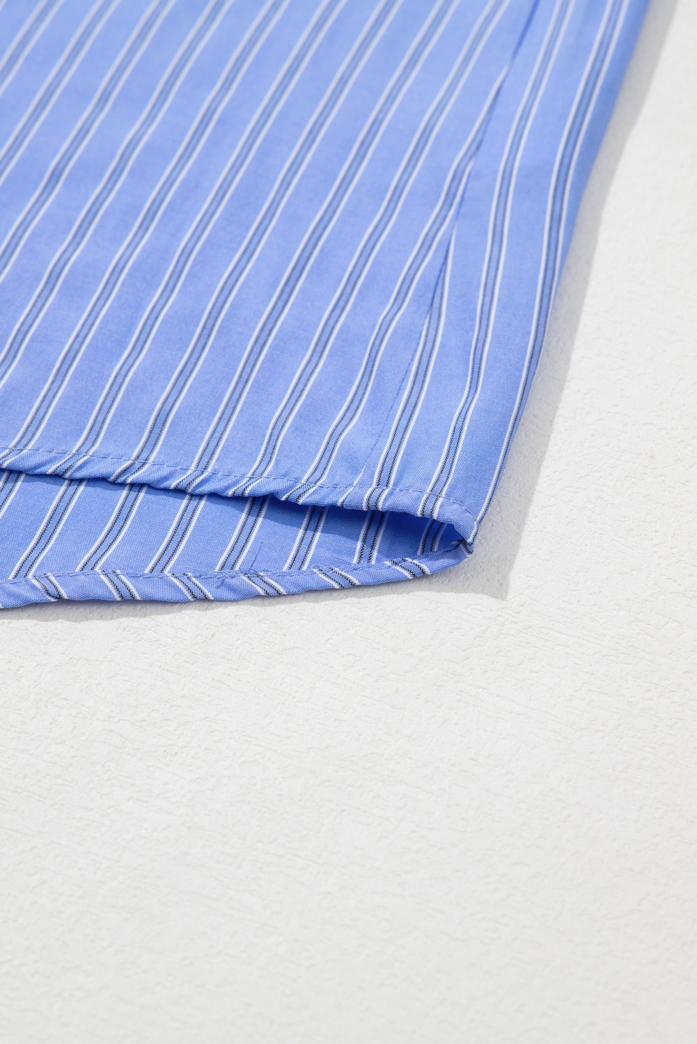 Add a touch of sophistication to your daily wear with this Women's Blue Stripe Oversized Button Up Casual Tunic Shirt. The long sleeves and shift silhouette provide coverage and a relaxed fit, making it perfect for casual gatherings, work, or running errands. The stylish striped pattern adds a classic and trendy twist to your outfit, while the button-up front adds a touch of elegance. Made from a soft blend of 60% polyester and 40% viscose, this shirt is comfortable and easy to care for. Paired with jeans, shorts, or skirts, this shirt is a versatile and chic addition to your wardrobe. Perfect for daily wear, this shirt is a must-have for any fashion enthusiast seeking a stylish and comfortable piece. - Detail View 9 Add a touch of sophistication to your daily wear with this Women's Blue Stripe Oversized Button Up Casual Tunic Shirt. The long sleeves and shift silhouette provide coverage and a relaxed fit, making it perfect for casual gatherings, work, or running errands. The stylish striped pattern adds a classic and trendy twist to your outfit, while the button-up front adds a touch of elegance. Made from a soft blend of 60% polyester and 40% viscose, this shirt is comfortable and easy to care for. Paired with jeans, shorts, or skirts, this shirt is a versatile and chic addition to your wardrobe. Perfect for daily wear, this shirt is a must-have for any fashion enthusiast seeking a stylish and comfortable piece. - Detail View 9