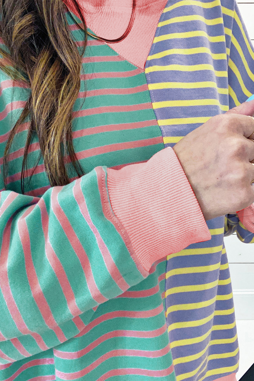 Elevate your casual wardrobe with this trendy Women's Casual Stripe Colorblock Drop Shoulder Oversize Sweatshirt. The oversized style gives the sweatshirt a casual and slouchy vibe, perfect for a relaxed and laid-back look. The color block design and stripe pattern combine seamlessly, adding a touch of visual interest to the sweatshirt. The drop shoulder design not only enhances the chic factor but also ensures a comfortable fit. Made from a premium blend of 95% cotton and 5% elastane, this sweatshirt offers both comfort and durability. The long sleeves provide added warmth, making it an ideal choice for the winter season. Pair it with casual pants or trendy leggings for a versatile and stylish ensemble. This sweatshirt for women caters to various faddish styles, making it a must-have addition to your winter wardrobe. - Detail View 4 Elevate your casual wardrobe with this trendy Women's Casual Stripe Colorblock Drop Shoulder Oversize Sweatshirt. The oversized style gives the sweatshirt a casual and slouchy vibe, perfect for a relaxed and laid-back look. The color block design and stripe pattern combine seamlessly, adding a touch of visual interest to the sweatshirt. The drop shoulder design not only enhances the chic factor but also ensures a comfortable fit. Made from a premium blend of 95% cotton and 5% elastane, this sweatshirt offers both comfort and durability. The long sleeves provide added warmth, making it an ideal choice for the winter season. Pair it with casual pants or trendy leggings for a versatile and stylish ensemble. This sweatshirt for women caters to various faddish styles, making it a must-have addition to your winter wardrobe. - Detail View 4