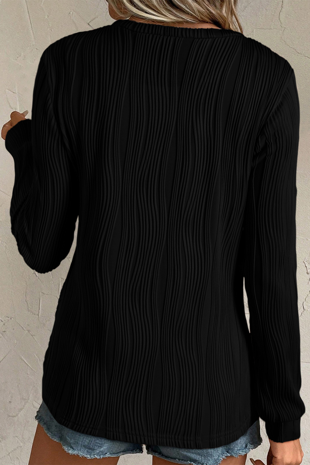 Elevate your casual wardrobe with this Women's Black Textured Wavy Round Neck Long Sleeve Top. The intricate wavy fabric texture adds a distinctive and tactile appeal to the classic round neck design, making it a timeless addition to your collection. Made from a premium blend of 91% polyester and 9% elastane, this top offers both comfort and durability. The solid black color and concise style make it versatile to style, pairing well with any fashionable jeans and pants. This elegant long sleeve top is perfect for daily wear and can easily transition from day to night. Its modern and sophisticated silhouette adds a touch of chic to any outfit, making it a must-have for the winter season. - Detail View 4 Elevate your casual wardrobe with this Women's Black Textured Wavy Round Neck Long Sleeve Top. The intricate wavy fabric texture adds a distinctive and tactile appeal to the classic round neck design, making it a timeless addition to your collection. Made from a premium blend of 91% polyester and 9% elastane, this top offers both comfort and durability. The solid black color and concise style make it versatile to style, pairing well with any fashionable jeans and pants. This elegant long sleeve top is perfect for daily wear and can easily transition from day to night. Its modern and sophisticated silhouette adds a touch of chic to any outfit, making it a must-have for the winter season. - Detail View 4