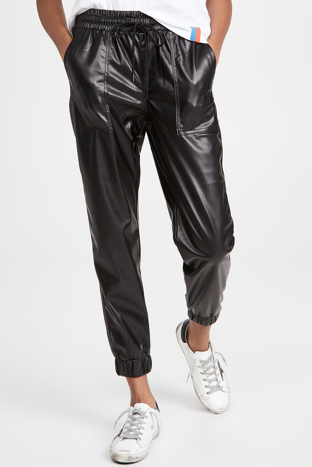 Elevate your everyday look with these fashionably designed Women's Black Faux Leather Ankle Smocked Waist Drawstring Joggers. Made from premium 100% PUL (polyurethane) faux leather, these joggers offer a unique and trendy edge. The drawstring waist allows for an adjustable fit, while the handy side pockets provide practical storage. The elastic hem ankles complement the tapered fit of the jogger silhouette, ensuring a comfortable and flattering fit. Style with a graphic tee and lifestyle sneakers for a chic and effortless everyday outfit. Perfect for women who want to stay fashionable and comfortable, these joggers are a must-have addition to your wardrobe. - Detail View 4 Elevate your everyday look with these fashionably designed Women's Black Faux Leather Ankle Smocked Waist Drawstring Joggers. Made from premium 100% PUL (polyurethane) faux leather, these joggers offer a unique and trendy edge. The drawstring waist allows for an adjustable fit, while the handy side pockets provide practical storage. The elastic hem ankles complement the tapered fit of the jogger silhouette, ensuring a comfortable and flattering fit. Style with a graphic tee and lifestyle sneakers for a chic and effortless everyday outfit. Perfect for women who want to stay fashionable and comfortable, these joggers are a must-have addition to your wardrobe. - Detail View 4