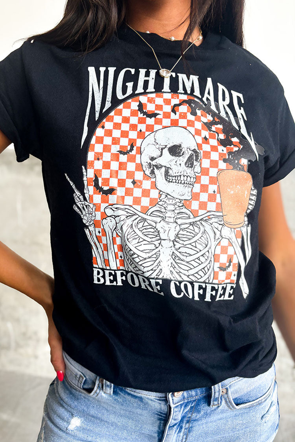 Casual Halloween Graphic Tee: Black Skull Design on Checkered Background - Detail View 2 Casual Halloween Graphic Tee: Black Skull Design on Checkered Background - Detail View 2