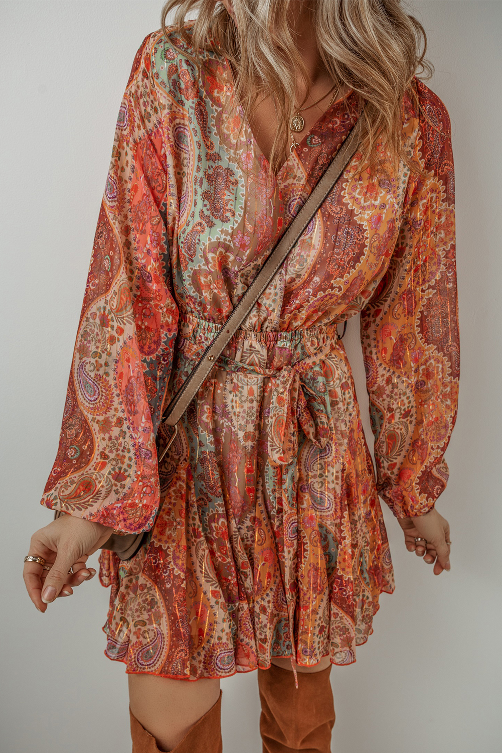 Make a vibrant nod to bohemian style with this Women's Orange Boho Paisley Print Long Sleeve Pleated Belted Mini Dress. The timeless Paisley print brings a touch of fashion to the dress, while the long sleeves and pleated hem create a playful and flirty look. The belted high waist accentuates the figure, adding a touch of sophistication to the overall silhouette. This mini dress is ideal for offering unique and charming styles, making it a must-have for daily wear or vacation. Made from premium 100% polyester, the dress ensures both quality and comfort. The A-line silhouette and mini length add a youthful and trendy vibe to the outfit, perfect for the spring season. Embrace your bohemian spirit with this chic and stylish mini dress, a standout piece in your wardrobe. - Detail View 4 Make a vibrant nod to bohemian style with this Women's Orange Boho Paisley Print Long Sleeve Pleated Belted Mini Dress. The timeless Paisley print brings a touch of fashion to the dress, while the long sleeves and pleated hem create a playful and flirty look. The belted high waist accentuates the figure, adding a touch of sophistication to the overall silhouette. This mini dress is ideal for offering unique and charming styles, making it a must-have for daily wear or vacation. Made from premium 100% polyester, the dress ensures both quality and comfort. The A-line silhouette and mini length add a youthful and trendy vibe to the outfit, perfect for the spring season. Embrace your bohemian spirit with this chic and stylish mini dress, a standout piece in your wardrobe. - Detail View 4