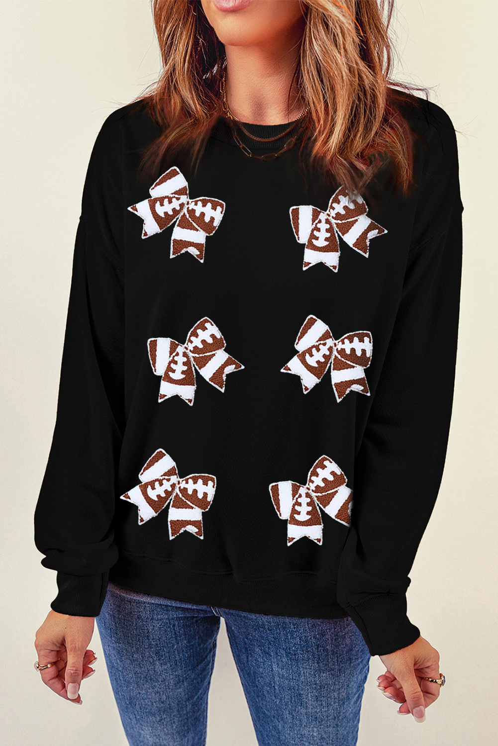 Show off your team spirit with this Women's Black Rugby Football Bowknot Patched Crew Neck Sweatshirt. The stylish design features bowknot shape patched patterns that add a playful touch to the sweatshirt. Perfect for game day attire or casual outings, this sweatshirt is a fun and spirited way to show your love for rugby football. Pair it with jeans or athletic wear to cheer on your favorite team. Made from a comfortable blend of 50% polyester and 50% cotton, this sweatshirt ensures a cozy fit and easy movement. Whether you're heading to a game or just lounging around, this graphic sweatshirt is a must-have for any sports fan. - Detail View 4 Show off your team spirit with this Women's Black Rugby Football Bowknot Patched Crew Neck Sweatshirt. The stylish design features bowknot shape patched patterns that add a playful touch to the sweatshirt. Perfect for game day attire or casual outings, this sweatshirt is a fun and spirited way to show your love for rugby football. Pair it with jeans or athletic wear to cheer on your favorite team. Made from a comfortable blend of 50% polyester and 50% cotton, this sweatshirt ensures a cozy fit and easy movement. Whether you're heading to a game or just lounging around, this graphic sweatshirt is a must-have for any sports fan. - Detail View 4