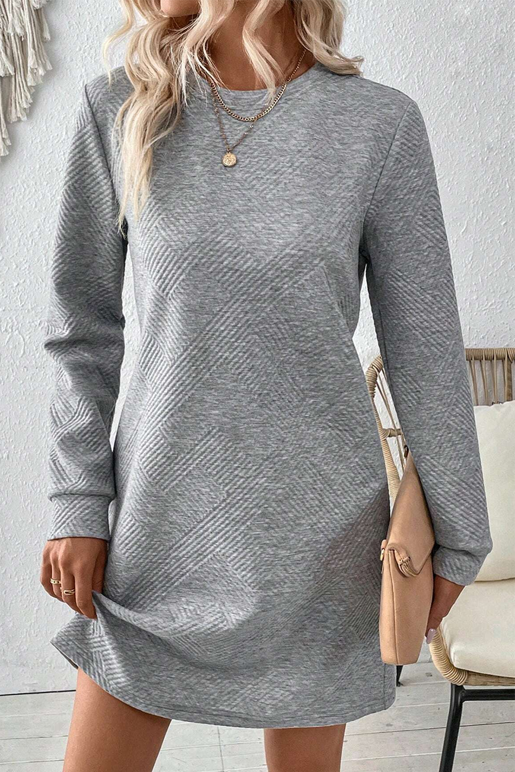 Add depth and unique appeal to your ensemble with this Women's Gray Textured Long Sleeve Shift Dress. The textured fabric of the dress creates a visually interesting look, while the long sleeves offer both style and coziness, making it a versatile piece for various occasions. The classic crew neck design adds a chic touch to the outfit, elevating your overall look. Embrace effortless elegance with the shift silhouette and flattering mini length, perfect for showcasing your fashion-forward style. Made from a premium blend of 97% polyester and 3% elastane, this dress ensures comfort and durability. The solid gray color and captivating texture make it a standout piece in your wardrobe. Pair it with heels for a sophisticated and polished look, or dress it down with sneakers for a more casual vibe. This stylish and modern shift dress is a must-have for the fall and autumn seasons, offering both fashion and comfort. - Detail View 4 Add depth and unique appeal to your ensemble with this Women's Gray Textured Long Sleeve Shift Dress. The textured fabric of the dress creates a visually interesting look, while the long sleeves offer both style and coziness, making it a versatile piece for various occasions. The classic crew neck design adds a chic touch to the outfit, elevating your overall look. Embrace effortless elegance with the shift silhouette and flattering mini length, perfect for showcasing your fashion-forward style. Made from a premium blend of 97% polyester and 3% elastane, this dress ensures comfort and durability. The solid gray color and captivating texture make it a standout piece in your wardrobe. Pair it with heels for a sophisticated and polished look, or dress it down with sneakers for a more casual vibe. This stylish and modern shift dress is a must-have for the fall and autumn seasons, offering both fashion and comfort. - Detail View 4