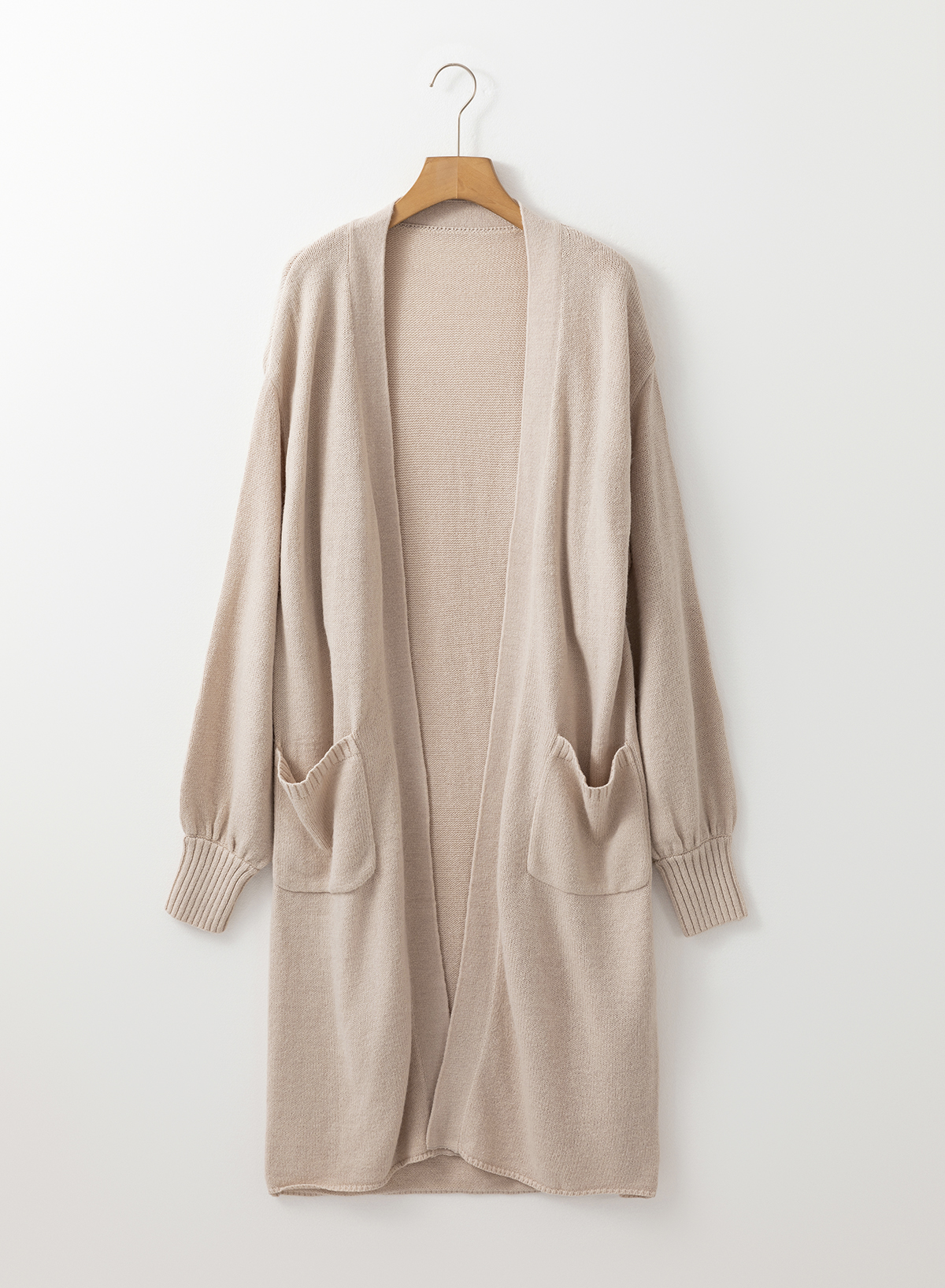 Transform your style with this elegant and comfortable Beige Long Knitted Cardigan. The open front design adds a touch of chic sophistication, while the puff sleeves provide a fashion-forward twist. Crafted from warm and cozy knitted fabric, this cardigan is perfect for daily wear during the winter season. The side pockets provide a practical touch, allowing you to easily store small essentials. Made from a blend of 60% acrylic and 40% polyamide, this cardigan is both durable and easy to care for. Elev your wardrobe with this trendy and comfortable cardigan, suitable for casual and daily wear. - Detail View 4 Transform your style with this elegant and comfortable Beige Long Knitted Cardigan. The open front design adds a touch of chic sophistication, while the puff sleeves provide a fashion-forward twist. Crafted from warm and cozy knitted fabric, this cardigan is perfect for daily wear during the winter season. The side pockets provide a practical touch, allowing you to easily store small essentials. Made from a blend of 60% acrylic and 40% polyamide, this cardigan is both durable and easy to care for. Elev your wardrobe with this trendy and comfortable cardigan, suitable for casual and daily wear. - Detail View 4