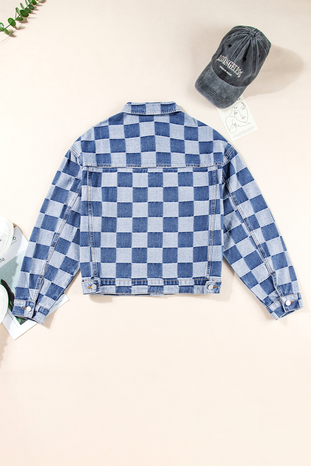 Elevate your casual style with this Women's Light Blue Checkered Patchwork Button-Up Denim Jacket. A unique fusion of classic denim and patchwork style, this jacket features a playful two-tone checkered pattern that adds a fun twist to the traditional denim look. The flap pockets and button-up front not only enhance the jacket's style but also provide practical functionality. Pair it with jeans for a trendy denim-on-denim look, or layer it over a simple tee for a laid-back and effortlessly cool ensemble. Made from a blend of 56% cotton and 44% polyester, this jacket offers both comfort and durability, making it ideal for the fall and autumn seasons. The long sleeves and turn-down collar add to the jacket's classic and timeless appeal. Show off your fashion taste with this stylish and versatile denim jacket. - Detail View 9 Elevate your casual style with this Women's Light Blue Checkered Patchwork Button-Up Denim Jacket. A unique fusion of classic denim and patchwork style, this jacket features a playful two-tone checkered pattern that adds a fun twist to the traditional denim look. The flap pockets and button-up front not only enhance the jacket's style but also provide practical functionality. Pair it with jeans for a trendy denim-on-denim look, or layer it over a simple tee for a laid-back and effortlessly cool ensemble. Made from a blend of 56% cotton and 44% polyester, this jacket offers both comfort and durability, making it ideal for the fall and autumn seasons. The long sleeves and turn-down collar add to the jacket's classic and timeless appeal. Show off your fashion taste with this stylish and versatile denim jacket. - Detail View 9