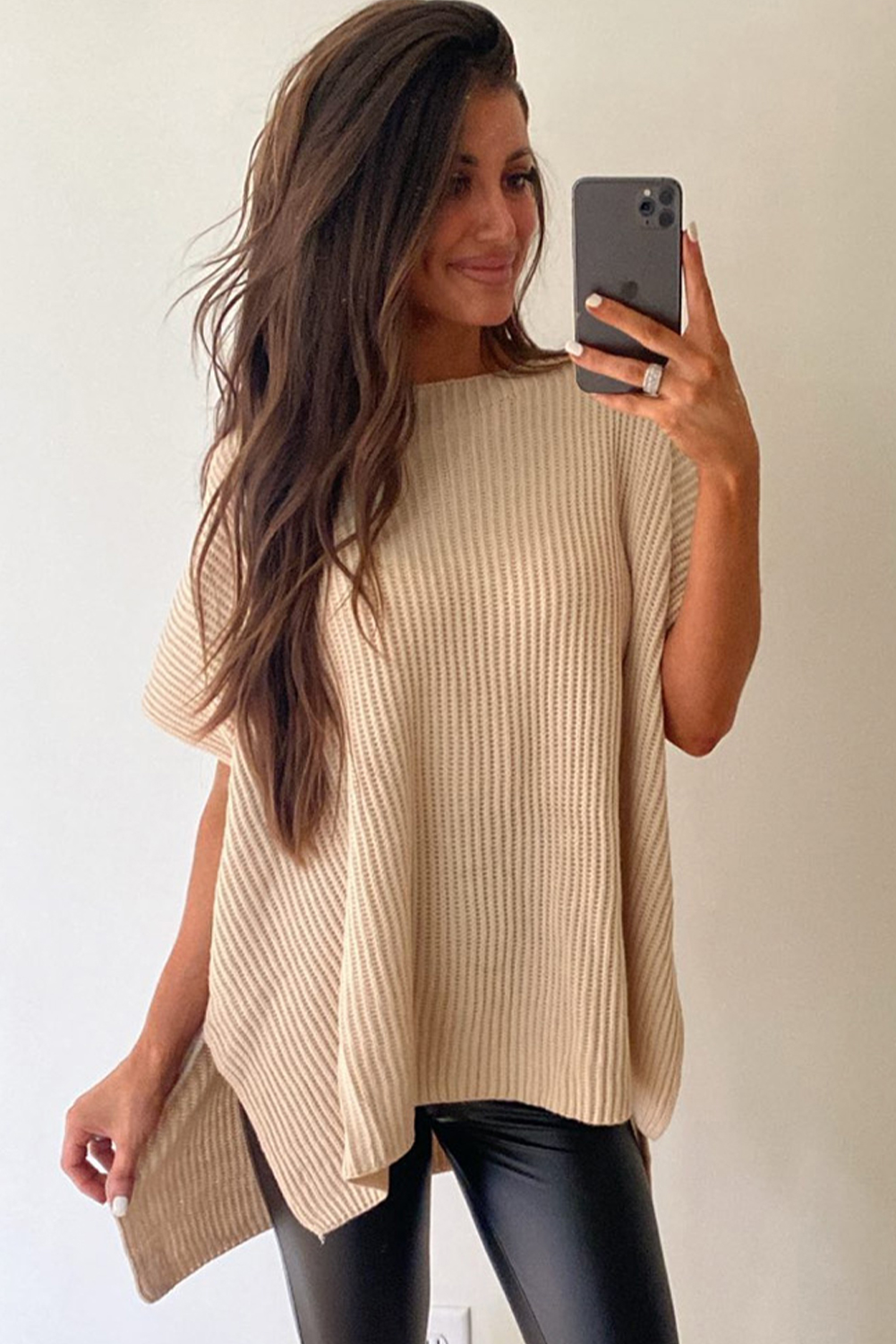 Elevate your style with this effortlessly chic Women's Apricot Short Sleeve Side Slit Oversized Sweater. The loose fit style offers a cozy and versatile look, perfect for daily wear. The wide short sleeves add a cool and modern touch to the sweater, while the tunic length provides a flattering silhouette. The side slits design adds unique detailing that will make you fall in love with this sweater. Made from a blend of 55% acrylic and 45% cotton, this sweater is comfortable and durable, making it an ideal choice for the fall and autumn seasons. Stay on-trend with the latest styles in women's sweaters, and add this modern and best-selling piece to your wardrobe. - Detail View 9 Elevate your style with this effortlessly chic Women's Apricot Short Sleeve Side Slit Oversized Sweater. The loose fit style offers a cozy and versatile look, perfect for daily wear. The wide short sleeves add a cool and modern touch to the sweater, while the tunic length provides a flattering silhouette. The side slits design adds unique detailing that will make you fall in love with this sweater. Made from a blend of 55% acrylic and 45% cotton, this sweater is comfortable and durable, making it an ideal choice for the fall and autumn seasons. Stay on-trend with the latest styles in women's sweaters, and add this modern and best-selling piece to your wardrobe. - Detail View 9
