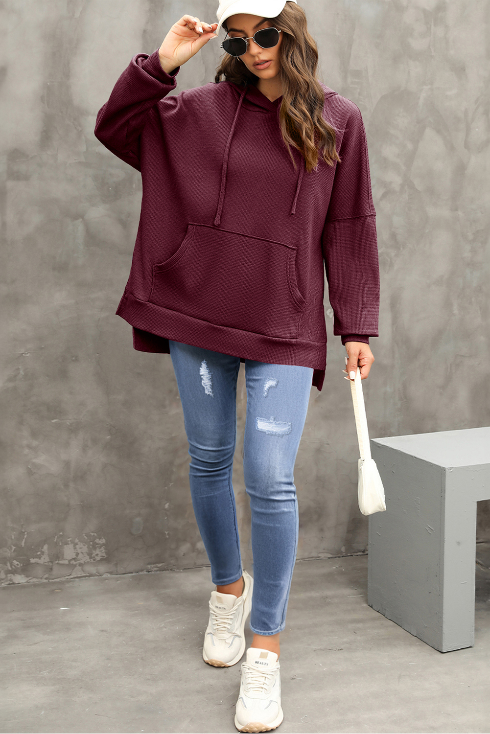Stay warm and stylish with this Women's Red Dahlia Waffle Knit Fleece Lined Oversized Hoodie. Crafted from soft jacquard knit fabric, this pullover hoodie offers a cozy and comfortable feel. The stylish high-low design and oversized fit enhance a casual and slender silhouette, making it a fashionable choice for the cooler seasons. The convenient kangaroo pocket not only adds a decorative touch but also provides storage for your essentials. The outstanding fleece-lined interior ensures superior warmth and comfort, making it perfect for fall and winter. Made from a premium blend of 75% polyester and 25% cotton, this hoodie offers durability and breathability. The solid red dahlia color adds a pop of brightness to your winter wardrobe. Versatile and stylish, this women's hoodie is a must-have for the upcoming seasons. - Detail View 9 Stay warm and stylish with this Women's Red Dahlia Waffle Knit Fleece Lined Oversized Hoodie. Crafted from soft jacquard knit fabric, this pullover hoodie offers a cozy and comfortable feel. The stylish high-low design and oversized fit enhance a casual and slender silhouette, making it a fashionable choice for the cooler seasons. The convenient kangaroo pocket not only adds a decorative touch but also provides storage for your essentials. The outstanding fleece-lined interior ensures superior warmth and comfort, making it perfect for fall and winter. Made from a premium blend of 75% polyester and 25% cotton, this hoodie offers durability and breathability. The solid red dahlia color adds a pop of brightness to your winter wardrobe. Versatile and stylish, this women's hoodie is a must-have for the upcoming seasons. - Detail View 9