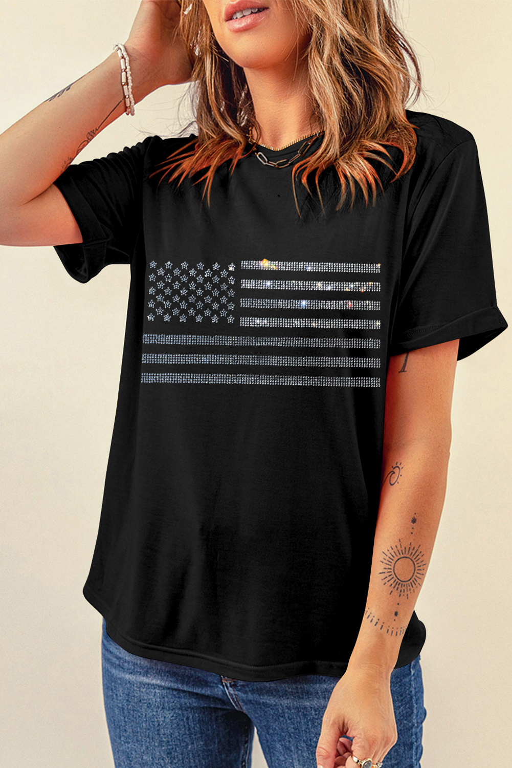 Add a touch of patriotism and glamour to your wardrobe with this Women's Black Glittering Rhinestone American Flag Pattern T-Shirt. The classic crew neck design ensures comfortable and versatile wear, while the short sleeves provide a casual and stylish look. The rhinestone embellishments add a glamorous touch, making this tee perfect for a night out or a casual day with friends. With a wholesale-friendly price, you can stock up and enhance your fashion game with diverse options. This graphic tee is a must-have for any woman who wants to make a statement and show her love for the United States. Perfect for summer wear, this tee is sure to be a hit with its bold black and rhinestone design. - Detail View 4 Add a touch of patriotism and glamour to your wardrobe with this Women's Black Glittering Rhinestone American Flag Pattern T-Shirt. The classic crew neck design ensures comfortable and versatile wear, while the short sleeves provide a casual and stylish look. The rhinestone embellishments add a glamorous touch, making this tee perfect for a night out or a casual day with friends. With a wholesale-friendly price, you can stock up and enhance your fashion game with diverse options. This graphic tee is a must-have for any woman who wants to make a statement and show her love for the United States. Perfect for summer wear, this tee is sure to be a hit with its bold black and rhinestone design. - Detail View 4