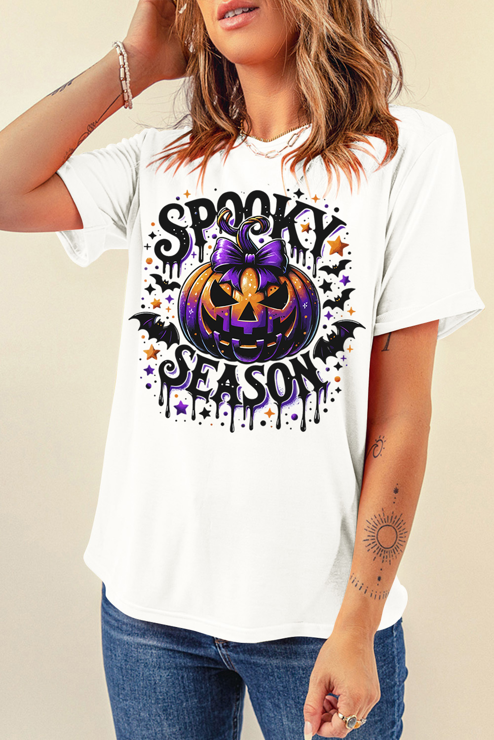 Get ready to celebrate the spookiest season of the year with this Women's White SPOOKY SEASON Pumpkin Bat Pattern Halloween T-Shirt. The bold SPOOKY SEASON letters on the chest add a trendy touch, while the playful pumpkin bat graphic brings a fun and festive element to your outfit. The classic crew neck design ensures a comfortable and versatile fit, and the short sleeves make it perfect for celebrating Halloween in style and comfort. This graphic tee is a great addition to your wardrobe, offering a unique and playful way to express your Halloween spirit. Pair it with your favorite jeans or leggings for a chic and stylish look. - Detail View 4 Get ready to celebrate the spookiest season of the year with this Women's White SPOOKY SEASON Pumpkin Bat Pattern Halloween T-Shirt. The bold SPOOKY SEASON letters on the chest add a trendy touch, while the playful pumpkin bat graphic brings a fun and festive element to your outfit. The classic crew neck design ensures a comfortable and versatile fit, and the short sleeves make it perfect for celebrating Halloween in style and comfort. This graphic tee is a great addition to your wardrobe, offering a unique and playful way to express your Halloween spirit. Pair it with your favorite jeans or leggings for a chic and stylish look. - Detail View 4