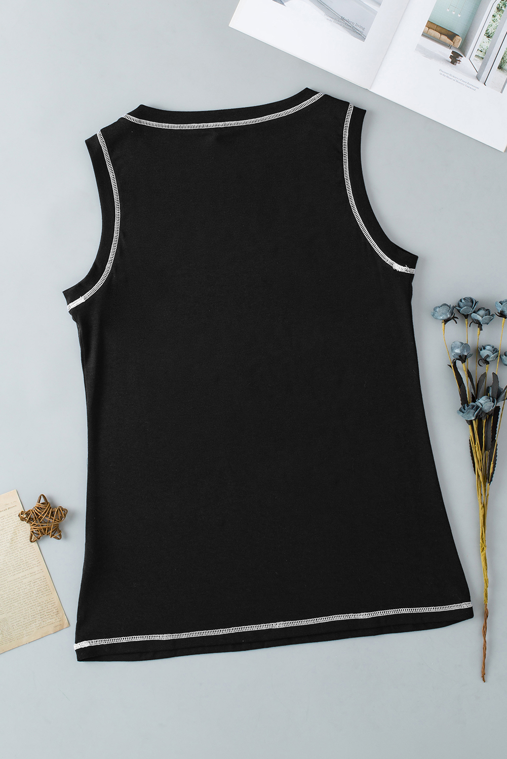Indulge in a garden of delights for the eyes with this Women's Black Letters Butterfly Floral Printed Stitching Crewneck Tank Top. The tank top features fluttering butterflies and floral prints that add a whimsical and charming touch to your outfit. The crew neck style is perfect for layering or wearing on its own, offering versatility in styling. The stitching details enhance the design, giving it an artisanal feel and adding a unique touch to the top. Made from a comfortable blend of 65% polyester, 30% viscose, and 5% elastane, this tank top ensures a comfortable and breathable fit. The black color and stylish prints make it an ideal choice for a casual summer look. Pair it with your favorite shorts or jeans for a trendy and effortless ensemble. This graphic tank top is a must-have addition to your summer wardrobe, offering both style and comfort. - Detail View 9 Indulge in a garden of delights for the eyes with this Women's Black Letters Butterfly Floral Printed Stitching Crewneck Tank Top. The tank top features fluttering butterflies and floral prints that add a whimsical and charming touch to your outfit. The crew neck style is perfect for layering or wearing on its own, offering versatility in styling. The stitching details enhance the design, giving it an artisanal feel and adding a unique touch to the top. Made from a comfortable blend of 65% polyester, 30% viscose, and 5% elastane, this tank top ensures a comfortable and breathable fit. The black color and stylish prints make it an ideal choice for a casual summer look. Pair it with your favorite shorts or jeans for a trendy and effortless ensemble. This graphic tank top is a must-have addition to your summer wardrobe, offering both style and comfort. - Detail View 9