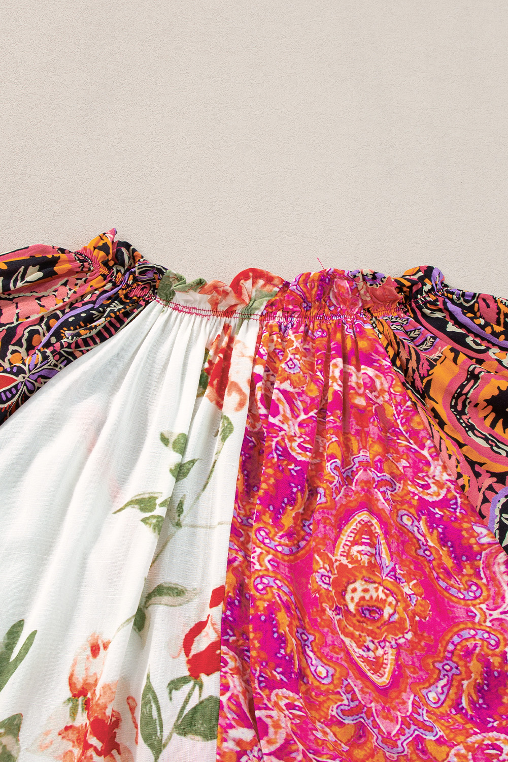 Make a statement with this unique and eye-catching Women's Multicolour Boho Floral Patchwork Buttoned Short Sleeve Blouse. The colorful floral print adds a touch of whimsy and playfulness to the overall design, while the button up front allows you to adjust the neckline and create different styles. The V neckline creates an elongating effect, drawing attention to the collarbone. The flowy silhouette and comfortable fit make it perfect for daily wear, while the 100% viscose material ensures a smooth and soft feel against your skin. This casual blouse is a must-have for your summer wardrobe, offering a unique and elegant look that's sure to turn heads. - Detail View 9 Make a statement with this unique and eye-catching Women's Multicolour Boho Floral Patchwork Buttoned Short Sleeve Blouse. The colorful floral print adds a touch of whimsy and playfulness to the overall design, while the button up front allows you to adjust the neckline and create different styles. The V neckline creates an elongating effect, drawing attention to the collarbone. The flowy silhouette and comfortable fit make it perfect for daily wear, while the 100% viscose material ensures a smooth and soft feel against your skin. This casual blouse is a must-have for your summer wardrobe, offering a unique and elegant look that's sure to turn heads. - Detail View 9