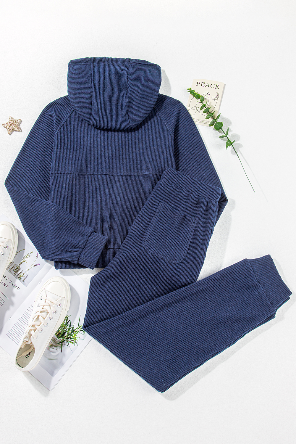 Elevate your activewear collection with this Women's Navy Blue Ribbed Knit Cropped Hoodie and Drawstring Joggers Set. The set includes a cropped hoodie and joggers, offering a coordinated and trendy outfit for your active lifestyle. The stylish ribbed knit design adds a textured look, while the adjustable drawstring on the waist ensures a customized and comfortable fit. Crafted from premium quality fabric, this set provides ultra comfort during workout sessions or casual wear. The hoodie features a hooded neckline and long sleeves, while the joggers come with a high waist and convenient pockets. Versatile and practical, this activewear set is perfect for both workouts and everyday activities. Stay chic and comfortable with this fashionable set in classic navy blue color. - Detail View 14 Elevate your activewear collection with this Women's Navy Blue Ribbed Knit Cropped Hoodie and Drawstring Joggers Set. The set includes a cropped hoodie and joggers, offering a coordinated and trendy outfit for your active lifestyle. The stylish ribbed knit design adds a textured look, while the adjustable drawstring on the waist ensures a customized and comfortable fit. Crafted from premium quality fabric, this set provides ultra comfort during workout sessions or casual wear. The hoodie features a hooded neckline and long sleeves, while the joggers come with a high waist and convenient pockets. Versatile and practical, this activewear set is perfect for both workouts and everyday activities. Stay chic and comfortable with this fashionable set in classic navy blue color. - Detail View 14