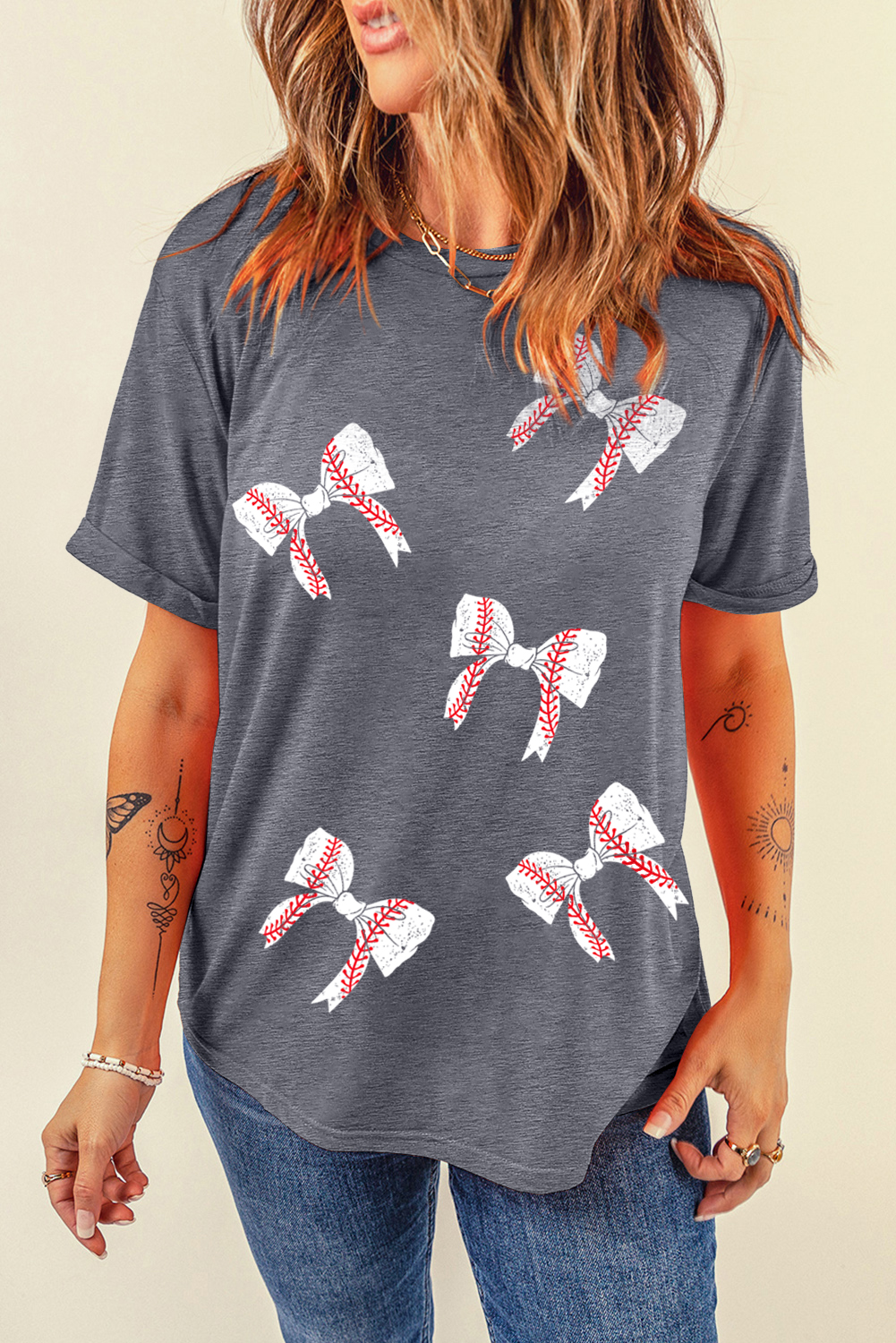 Elevate your casual wardrobe with this Women's Gray Rugby Bow Knot Print Crewneck T-Shirt. The chic ball seams add a unique touch to the bowknot graphic, making this t-shirt both girlish and sporty in style. Crafted from a soft and comfortable 62% polyester, 32% cotton, and 6% elastane blend, it is designed on our trendy round neck tee with rolled sleeves. Perfect for daily wear during the summer season, this graphic t-shirt offers a casual and stylish look. The gray color and abstract pattern make it versatile for pairing with various bottoms and accessories. Explore all kinds of ping graphic tees for women to complete your trendy and fashionable ensemble. - Detail View 4 Elevate your casual wardrobe with this Women's Gray Rugby Bow Knot Print Crewneck T-Shirt. The chic ball seams add a unique touch to the bowknot graphic, making this t-shirt both girlish and sporty in style. Crafted from a soft and comfortable 62% polyester, 32% cotton, and 6% elastane blend, it is designed on our trendy round neck tee with rolled sleeves. Perfect for daily wear during the summer season, this graphic t-shirt offers a casual and stylish look. The gray color and abstract pattern make it versatile for pairing with various bottoms and accessories. Explore all kinds of ping graphic tees for women to complete your trendy and fashionable ensemble. - Detail View 4