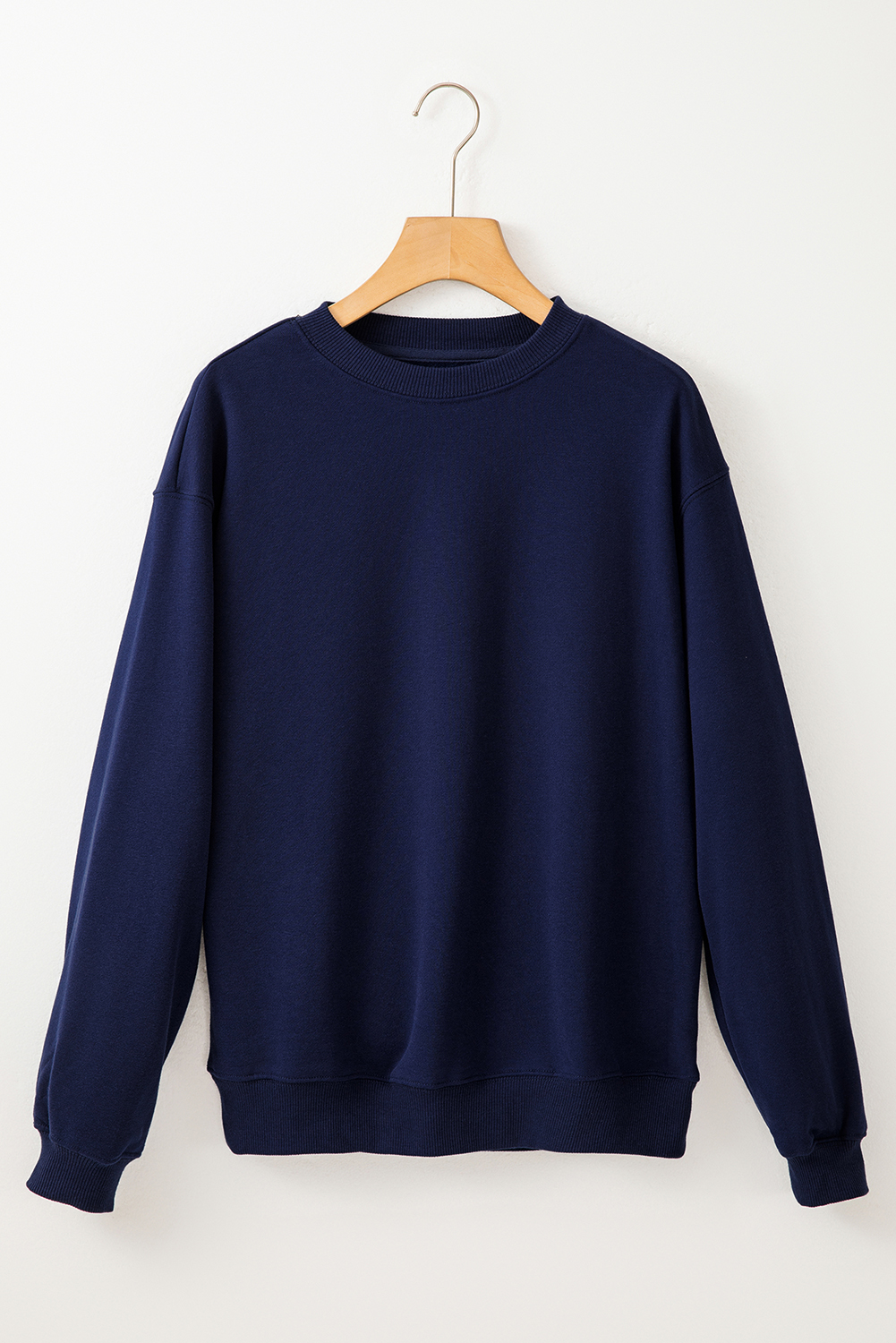 Stay warm and stylish with this Women's Navy Blue Solid Fleece-Lined Drop Shoulder Terry Sweatshirt. The simple yet stylish design makes it versatile for various occasions. The fleece-lined interior provides exceptional warmth, making it the perfect choice for the cold winter season. The drop shoulder design adds a modern touch to the sweatshirt, while the long sleeves ensure comfort and warmth in cooler weather. Made from a premium blend of 50% polyester and 50% cotton, this sweatshirt offers durability and a soft feel against the skin. The solid navy blue color adds a classic and timeless appeal to the sweatshirt, making it easy to pair with different bottoms. This cozy and chic sweatshirt is a must-have addition to your winter wardrobe, offering both style and comfort. - Detail View 4 Stay warm and stylish with this Women's Navy Blue Solid Fleece-Lined Drop Shoulder Terry Sweatshirt. The simple yet stylish design makes it versatile for various occasions. The fleece-lined interior provides exceptional warmth, making it the perfect choice for the cold winter season. The drop shoulder design adds a modern touch to the sweatshirt, while the long sleeves ensure comfort and warmth in cooler weather. Made from a premium blend of 50% polyester and 50% cotton, this sweatshirt offers durability and a soft feel against the skin. The solid navy blue color adds a classic and timeless appeal to the sweatshirt, making it easy to pair with different bottoms. This cozy and chic sweatshirt is a must-have addition to your winter wardrobe, offering both style and comfort. - Detail View 4