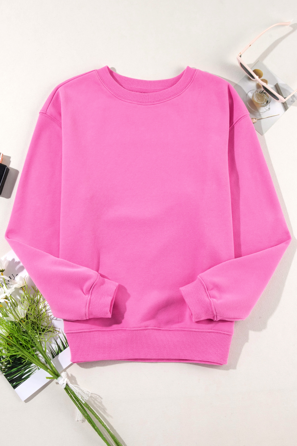 Elevate your winter wardrobe with this Women's Bonbon Solid Fleece Lined Drop Shoulder Terry Sweatshirt. The simple yet stylish design of this sweatshirt offers versatile wear options. It features a classic crew neck for a timeless look, while the drop shoulder design adds a modern and trendy touch. The long sleeves provide comfort and warmth, making it ideal for cooler weather. Made from a blend of 50% polyester and 50% cotton, this sweatshirt ensures durability and a soft feel against the skin. The bonbon pink color adds a pop of brightness to your winter outfits. The fleece lining provides extra warmth and coziness, perfect for the winter season. Pair this sweatshirt with your favorite jeans or leggings for a casual and comfortable look. Embrace the comfort and style of this must-have winter essential. - Detail View 4 Elevate your winter wardrobe with this Women's Bonbon Solid Fleece Lined Drop Shoulder Terry Sweatshirt. The simple yet stylish design of this sweatshirt offers versatile wear options. It features a classic crew neck for a timeless look, while the drop shoulder design adds a modern and trendy touch. The long sleeves provide comfort and warmth, making it ideal for cooler weather. Made from a blend of 50% polyester and 50% cotton, this sweatshirt ensures durability and a soft feel against the skin. The bonbon pink color adds a pop of brightness to your winter outfits. The fleece lining provides extra warmth and coziness, perfect for the winter season. Pair this sweatshirt with your favorite jeans or leggings for a casual and comfortable look. Embrace the comfort and style of this must-have winter essential. - Detail View 4