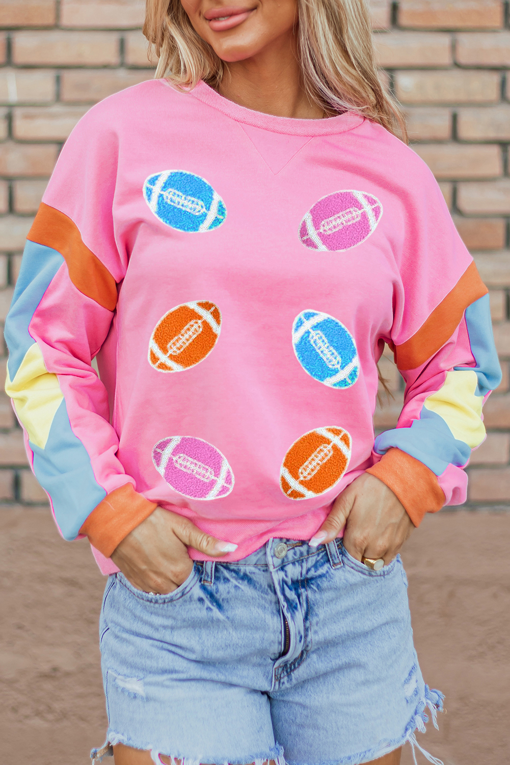 Get ready for game day with this eye-catching Women's Pink Rugby Football Patchwork Color Block T-Shirt. The vibrant pink color and striking rugby football patterns make it a stylish option for sports fans. The crew neck and short sleeves provide a relaxed fit, while the colorblock design adds a fun and playful touch. Pair it with jeans or athletic wear for a sporty outfit that's ready for the big game. The graphic long sleeve tee is perfect for summertime, and the casual style makes it ideal for daily wear. - Detail View 4 Get ready for game day with this eye-catching Women's Pink Rugby Football Patchwork Color Block T-Shirt. The vibrant pink color and striking rugby football patterns make it a stylish option for sports fans. The crew neck and short sleeves provide a relaxed fit, while the colorblock design adds a fun and playful touch. Pair it with jeans or athletic wear for a sporty outfit that's ready for the big game. The graphic long sleeve tee is perfect for summertime, and the casual style makes it ideal for daily wear. - Detail View 4