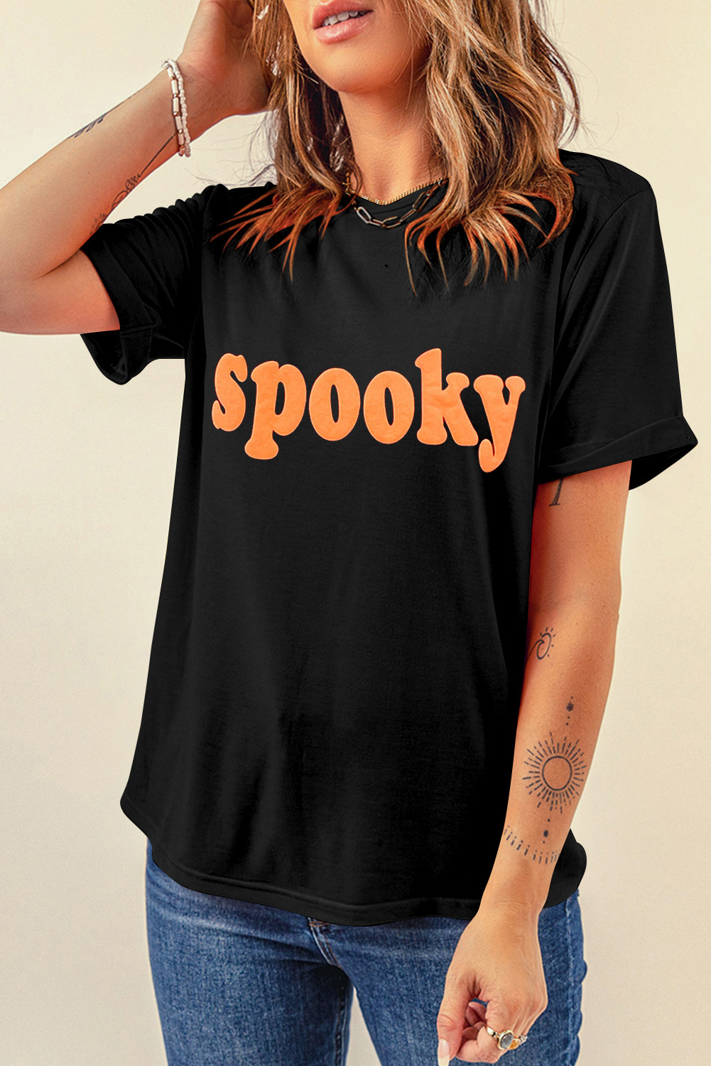 Make a statement with this Women's Black Halloween Spooky Crew Neck Graphic Tee. Embrace the Halloween spirit with the fun and festive theme, featuring spooky lettering that adds a touch of mystery and excitement. The classic crew neck design ensures comfort for everyday wear, making it perfect for casual occasions. The short sleeves offer a laid-back look, ideal for the summer season. Made from a blend of 62% polyester, 32% cotton, and 6% elastane, this t-shirt provides a comfortable and breathable fit. Stand out from the crowd and express your Halloween enthusiasm with this stylish graphic tee. Explore the variety of options available in our collection of graphic tees. - Detail View 4 Make a statement with this Women's Black Halloween Spooky Crew Neck Graphic Tee. Embrace the Halloween spirit with the fun and festive theme, featuring spooky lettering that adds a touch of mystery and excitement. The classic crew neck design ensures comfort for everyday wear, making it perfect for casual occasions. The short sleeves offer a laid-back look, ideal for the summer season. Made from a blend of 62% polyester, 32% cotton, and 6% elastane, this t-shirt provides a comfortable and breathable fit. Stand out from the crowd and express your Halloween enthusiasm with this stylish graphic tee. Explore the variety of options available in our collection of graphic tees. - Detail View 4