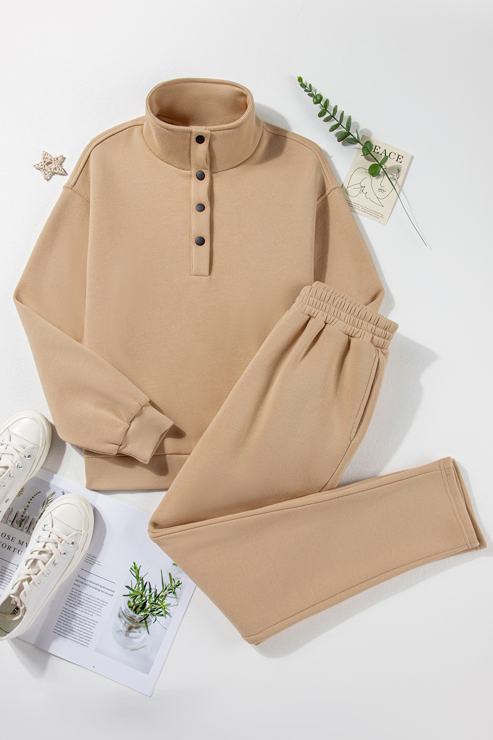 Stay stylish and cozy with this Women's Parchment Solid Half Button Sweatshirt and High Waist Sweatpants Set. The chic half button sweatshirt offers a trendy and comfortable fit, while the high waist sweatpants provide a flattering silhouette and a cozy feel. The set is available in a variety of solid colors to suit your mood and style preferences. The loose fit design ensures all-day comfort and ease of movement, making it ideal for daily wear and outdoor activities. Elevate your loungewear game with this fashionable and functional active set, perfect for the winter season. Made from a premium blend of 50% polyester and 50% cotton, this set offers durability and breathability. Stay comfortable and stylish with this versatile activewear set. - Detail View 9 Stay stylish and cozy with this Women's Parchment Solid Half Button Sweatshirt and High Waist Sweatpants Set. The chic half button sweatshirt offers a trendy and comfortable fit, while the high waist sweatpants provide a flattering silhouette and a cozy feel. The set is available in a variety of solid colors to suit your mood and style preferences. The loose fit design ensures all-day comfort and ease of movement, making it ideal for daily wear and outdoor activities. Elevate your loungewear game with this fashionable and functional active set, perfect for the winter season. Made from a premium blend of 50% polyester and 50% cotton, this set offers durability and breathability. Stay comfortable and stylish with this versatile activewear set. - Detail View 9