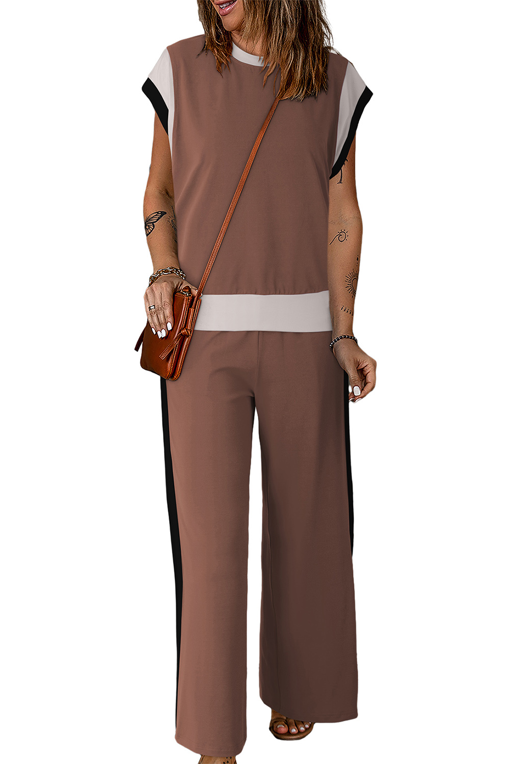 Elevate your casual wardrobe with this eye-catching Women's Chestnut Color Block Detail Casual Two-piece Outfit. The set includes a crew neck cap sleeve tee and crop wide leg pants, both designed with a stylish colorblock detail that adds a touch of uniqueness to the solid ensemble. The loose fit of the outfit is friendly for most body shapes, offering both style and comfort. Crafted with fine fabric, this set is ideal for warm weather, providing a stylish and comfy option for your daily wear. The high-waisted wide leg pants add a trendy and chic element to the outfit, making it a hot-selling choice for casual styles. Embrace the summer season in this fashionable two-piece set that combines elegance and ease. - Detail View 9 Elevate your casual wardrobe with this eye-catching Women's Chestnut Color Block Detail Casual Two-piece Outfit. The set includes a crew neck cap sleeve tee and crop wide leg pants, both designed with a stylish colorblock detail that adds a touch of uniqueness to the solid ensemble. The loose fit of the outfit is friendly for most body shapes, offering both style and comfort. Crafted with fine fabric, this set is ideal for warm weather, providing a stylish and comfy option for your daily wear. The high-waisted wide leg pants add a trendy and chic element to the outfit, making it a hot-selling choice for casual styles. Embrace the summer season in this fashionable two-piece set that combines elegance and ease. - Detail View 9