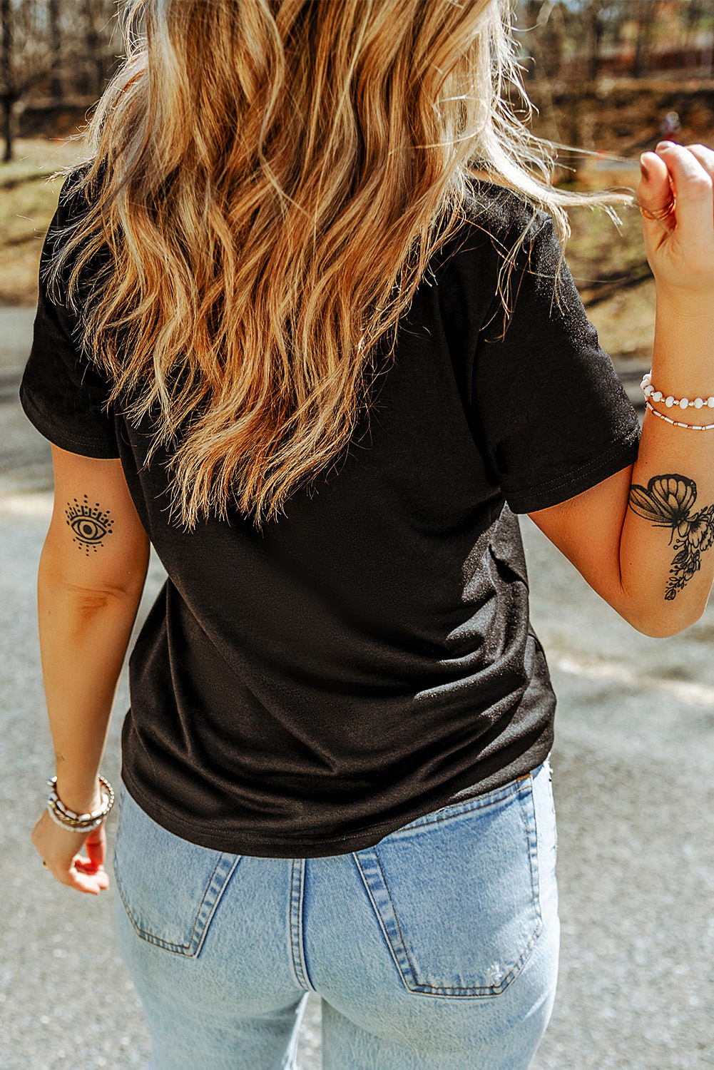 Make a bold statement with this Women's Black Rhinestone Skull Graphic Crew Neck T-Shirt. The edgy skull graphic adds a touch of sass, while the sparkling rhinestones shine bright. This short sleeve top offers comfort and style, perfect for daily and casual summer wear. The classic crew neck design provides a versatile look, easy to pair with jeans, shorts, or even go out with a flowy skirt. The delicate cuttings and attractive prices of this graphic tee make it a must-have addition to your wardrobe. - Detail View 4 Make a bold statement with this Women's Black Rhinestone Skull Graphic Crew Neck T-Shirt. The edgy skull graphic adds a touch of sass, while the sparkling rhinestones shine bright. This short sleeve top offers comfort and style, perfect for daily and casual summer wear. The classic crew neck design provides a versatile look, easy to pair with jeans, shorts, or even go out with a flowy skirt. The delicate cuttings and attractive prices of this graphic tee make it a must-have addition to your wardrobe. - Detail View 4