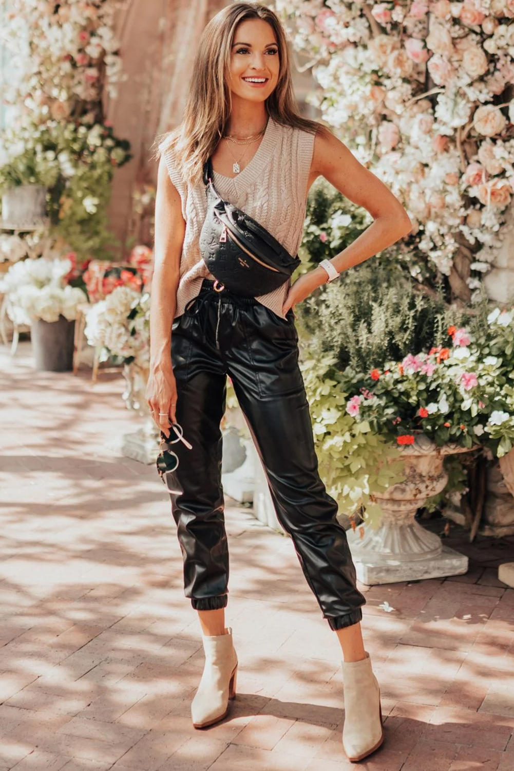 Elevate your everyday look with these fashionably designed Women's Black Faux Leather Ankle Smocked Waist Drawstring Joggers. Made from premium 100% PUL (polyurethane) faux leather, these joggers offer a unique and trendy edge. The drawstring waist allows for an adjustable fit, while the handy side pockets provide practical storage. The elastic hem ankles complement the tapered fit of the jogger silhouette, ensuring a comfortable and flattering fit. Style with a graphic tee and lifestyle sneakers for a chic and effortless everyday outfit. Perfect for women who want to stay fashionable and comfortable, these joggers are a must-have addition to your wardrobe. - Detail View 9 Elevate your everyday look with these fashionably designed Women's Black Faux Leather Ankle Smocked Waist Drawstring Joggers. Made from premium 100% PUL (polyurethane) faux leather, these joggers offer a unique and trendy edge. The drawstring waist allows for an adjustable fit, while the handy side pockets provide practical storage. The elastic hem ankles complement the tapered fit of the jogger silhouette, ensuring a comfortable and flattering fit. Style with a graphic tee and lifestyle sneakers for a chic and effortless everyday outfit. Perfect for women who want to stay fashionable and comfortable, these joggers are a must-have addition to your wardrobe. - Detail View 9