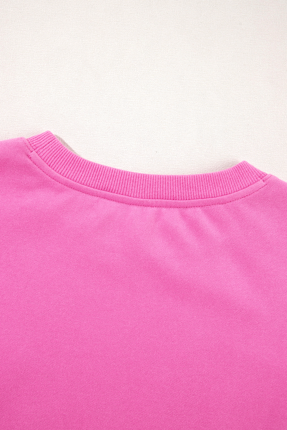 Elevate your winter wardrobe with this Women's Bonbon Solid Fleece Lined Drop Shoulder Terry Sweatshirt. The simple yet stylish design of this sweatshirt offers versatile wear options. It features a classic crew neck for a timeless look, while the drop shoulder design adds a modern and trendy touch. The long sleeves provide comfort and warmth, making it ideal for cooler weather. Made from a blend of 50% polyester and 50% cotton, this sweatshirt ensures durability and a soft feel against the skin. The bonbon pink color adds a pop of brightness to your winter outfits. The fleece lining provides extra warmth and coziness, perfect for the winter season. Pair this sweatshirt with your favorite jeans or leggings for a casual and comfortable look. Embrace the comfort and style of this must-have winter essential. - Detail View 9 Elevate your winter wardrobe with this Women's Bonbon Solid Fleece Lined Drop Shoulder Terry Sweatshirt. The simple yet stylish design of this sweatshirt offers versatile wear options. It features a classic crew neck for a timeless look, while the drop shoulder design adds a modern and trendy touch. The long sleeves provide comfort and warmth, making it ideal for cooler weather. Made from a blend of 50% polyester and 50% cotton, this sweatshirt ensures durability and a soft feel against the skin. The bonbon pink color adds a pop of brightness to your winter outfits. The fleece lining provides extra warmth and coziness, perfect for the winter season. Pair this sweatshirt with your favorite jeans or leggings for a casual and comfortable look. Embrace the comfort and style of this must-have winter essential. - Detail View 9