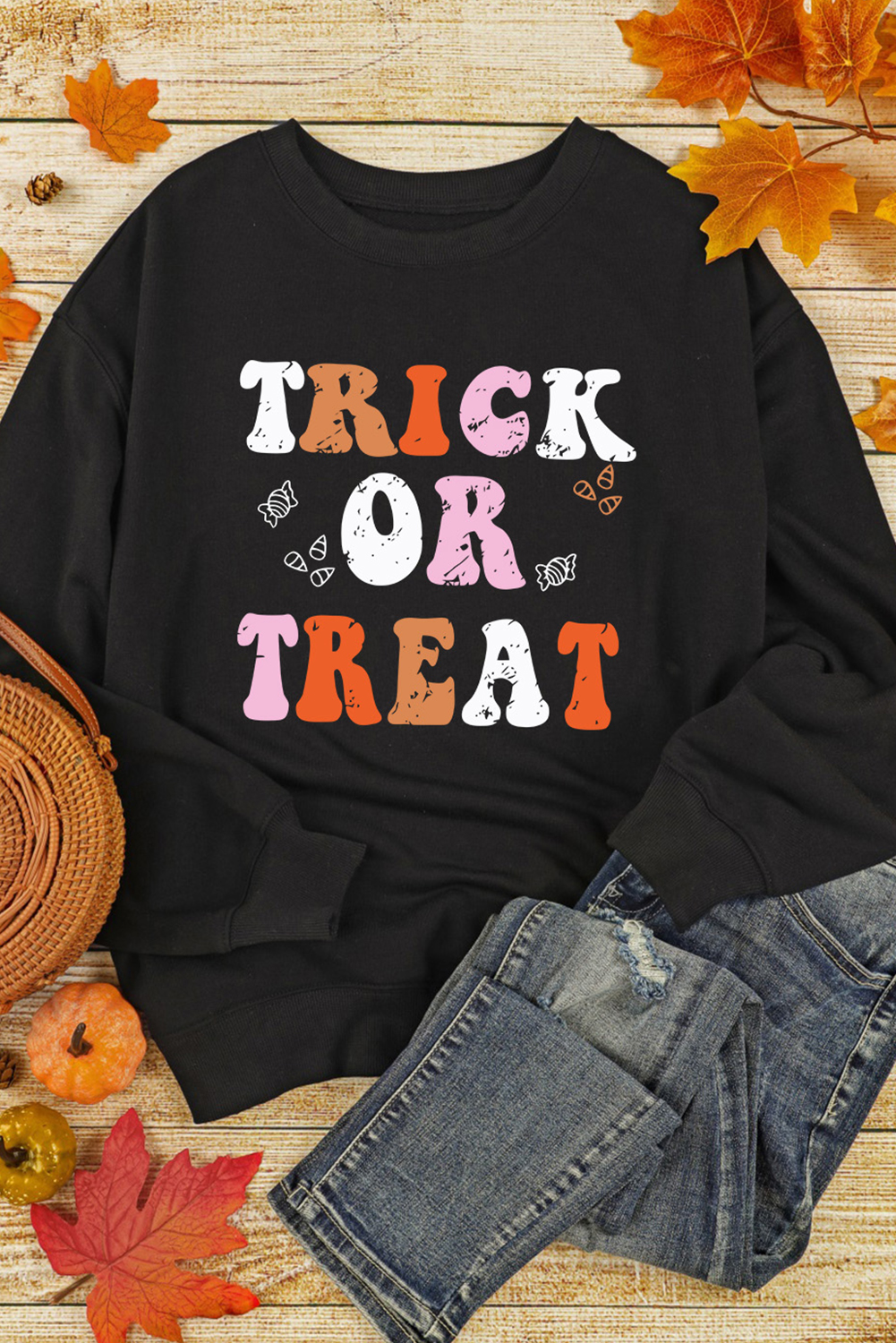 Embrace the Halloween spirit with this Women's Black TRICK OR TREAT Graphic Crewneck Halloween Sweatshirt. The cozy and festive sweatshirt is the perfect option for the Halloween season, offering a classic and comfortable style with its crewneck design and baggy fit. The playful TRICK OR TREAT graphic captures the essence of Halloween, adding a fun and spirited touch to your outfit. Made from a blend of 50% polyester and 50% cotton, this sweatshirt ensures both comfort and durability. Pair it with costume bottoms or casual jeans for a complete Halloween look, whether you're out trick-or-treating or attending festive gatherings. The long sleeves and round neck provide additional warmth for outdoor festivities, keeping you cozy and stylish throughout the season. - Detail View 9 Embrace the Halloween spirit with this Women's Black TRICK OR TREAT Graphic Crewneck Halloween Sweatshirt. The cozy and festive sweatshirt is the perfect option for the Halloween season, offering a classic and comfortable style with its crewneck design and baggy fit. The playful TRICK OR TREAT graphic captures the essence of Halloween, adding a fun and spirited touch to your outfit. Made from a blend of 50% polyester and 50% cotton, this sweatshirt ensures both comfort and durability. Pair it with costume bottoms or casual jeans for a complete Halloween look, whether you're out trick-or-treating or attending festive gatherings. The long sleeves and round neck provide additional warmth for outdoor festivities, keeping you cozy and stylish throughout the season. - Detail View 9