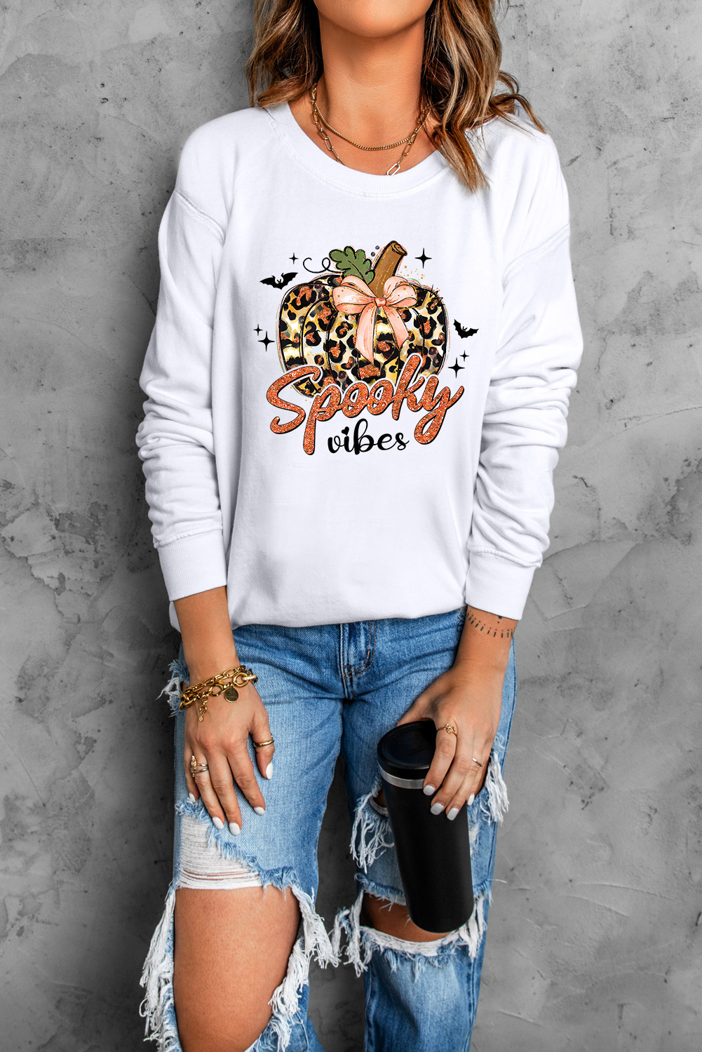 Get into the Halloween spirit with this Women's Beige Spooky Leopard Pumpkin Print Crew Neck Sweatshirt. Stand out with the unique and spooky leopard pumpkin graphic print, perfect for adding a touch of Halloween fun to your outfit. The classic crew neck style offers a comfortable and casual look, while the long sleeves keep you cozy and stylish for the season. Made from a premium blend of 50% polyester and 50% cotton, this sweatshirt ensures durability and comfort for all-day wear. The versatile style of graphic sweatshirts makes it a must-have for updating your wardrobe and adding a playful twist to your daily outfits. - Detail View 4 Get into the Halloween spirit with this Women's Beige Spooky Leopard Pumpkin Print Crew Neck Sweatshirt. Stand out with the unique and spooky leopard pumpkin graphic print, perfect for adding a touch of Halloween fun to your outfit. The classic crew neck style offers a comfortable and casual look, while the long sleeves keep you cozy and stylish for the season. Made from a premium blend of 50% polyester and 50% cotton, this sweatshirt ensures durability and comfort for all-day wear. The versatile style of graphic sweatshirts makes it a must-have for updating your wardrobe and adding a playful twist to your daily outfits. - Detail View 4