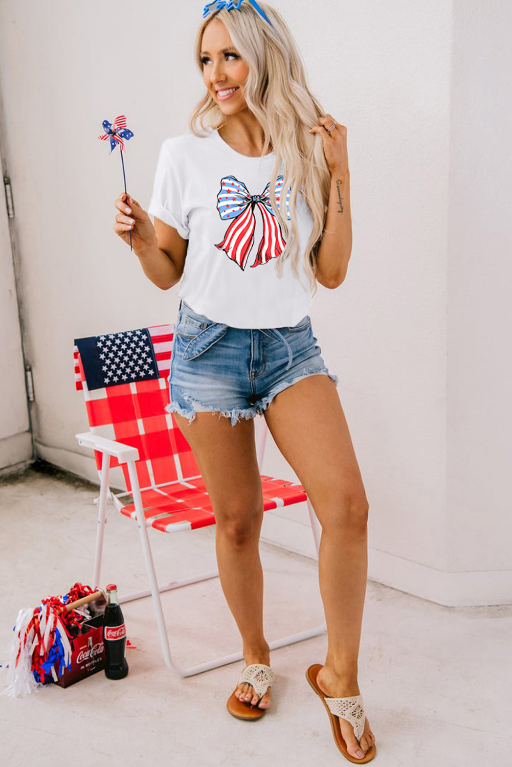 Add a touch of casual chic to your wardrobe with this Women's White Stripes and Stars Bowknot Print T-Shirt. The round neck and short-sleeve design offer a comfortable and relaxed fit, perfect for daily wear. The classic white color provides versatility and effortless style, while the striped and stars bowknot print adds a fun and trendy element to the tee. Made from a blend of 62% polyester, 32% cotton, and 6% elastane, this t-shirt ensures a soft and breathable feel against the skin. The shift silhouette allows for easy movement and a flattering fit for various body shapes. Ideal for the summer season, this graphic print tee is a stylish choice for casual outings and day-to-day activities. Pair it with your favorite jeans or shorts for a laid-back and fashionable look. - Detail View 9 Add a touch of casual chic to your wardrobe with this Women's White Stripes and Stars Bowknot Print T-Shirt. The round neck and short-sleeve design offer a comfortable and relaxed fit, perfect for daily wear. The classic white color provides versatility and effortless style, while the striped and stars bowknot print adds a fun and trendy element to the tee. Made from a blend of 62% polyester, 32% cotton, and 6% elastane, this t-shirt ensures a soft and breathable feel against the skin. The shift silhouette allows for easy movement and a flattering fit for various body shapes. Ideal for the summer season, this graphic print tee is a stylish choice for casual outings and day-to-day activities. Pair it with your favorite jeans or shorts for a laid-back and fashionable look. - Detail View 9