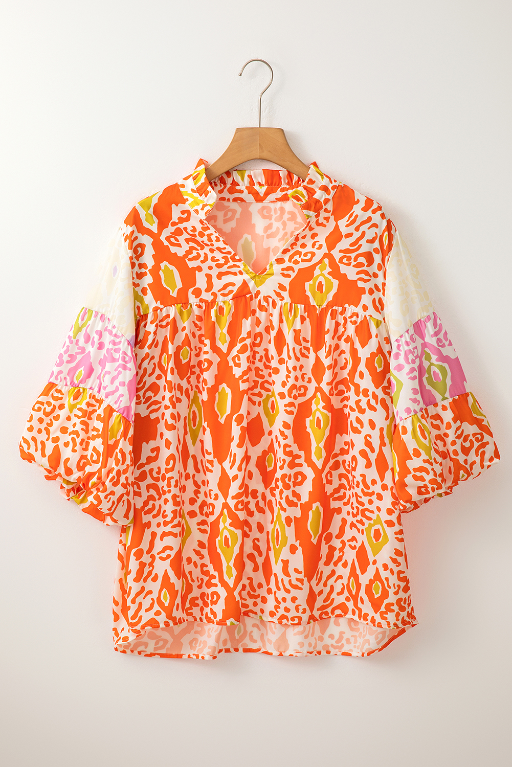 Make a fierce and trendy statement with this Women's Orange Leopard Colorblock Puff Sleeve Split Neck Blouse. The bold leopard print combined with the modern colorblock design adds a fashionable and edgy twist to the blouse, making it a standout piece in your wardrobe. The stylish puff sleeves create an eye-catching silhouette, while the flattering V neckline adds a touch of chic elegance. Made from premium 100% polyester, this blouse offers both comfort and durability. The versatile style of this blouse allows for various wardrobe combinations, making it a must-have for your summer wardrobe update. Whether you're dressing up for a special occasion or keeping it casual for daily wear, this blouse offers endless styling possibilities and is sure to turn heads. - Detail View 9 Make a fierce and trendy statement with this Women's Orange Leopard Colorblock Puff Sleeve Split Neck Blouse. The bold leopard print combined with the modern colorblock design adds a fashionable and edgy twist to the blouse, making it a standout piece in your wardrobe. The stylish puff sleeves create an eye-catching silhouette, while the flattering V neckline adds a touch of chic elegance. Made from premium 100% polyester, this blouse offers both comfort and durability. The versatile style of this blouse allows for various wardrobe combinations, making it a must-have for your summer wardrobe update. Whether you're dressing up for a special occasion or keeping it casual for daily wear, this blouse offers endless styling possibilities and is sure to turn heads. - Detail View 9