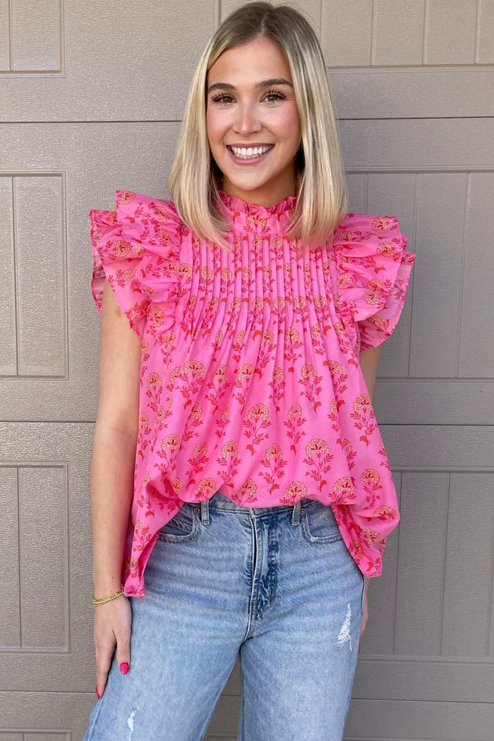 Update your wardrobe with our charming Rose Red Floral Print Pleated Ruffled Flutter Sleeve Blouse. The blouse features a soft and flowing silhouette with flutter sleeves, adding a touch of whimsy and movement. Delicate ruffles adorn the sleeves, giving the garment a soft and feminine touch. The pleating detail adds texture and sophistication to the design, making it a sophisticated and elegant choice for daily wear. Perfect for those who love to add a touch of charm and romance to their outfits. This blouse is a must-have for your wardrobe, offering versatile styles and a romantic flair. - Detail View 4 Update your wardrobe with our charming Rose Red Floral Print Pleated Ruffled Flutter Sleeve Blouse. The blouse features a soft and flowing silhouette with flutter sleeves, adding a touch of whimsy and movement. Delicate ruffles adorn the sleeves, giving the garment a soft and feminine touch. The pleating detail adds texture and sophistication to the design, making it a sophisticated and elegant choice for daily wear. Perfect for those who love to add a touch of charm and romance to their outfits. This blouse is a must-have for your wardrobe, offering versatile styles and a romantic flair. - Detail View 4