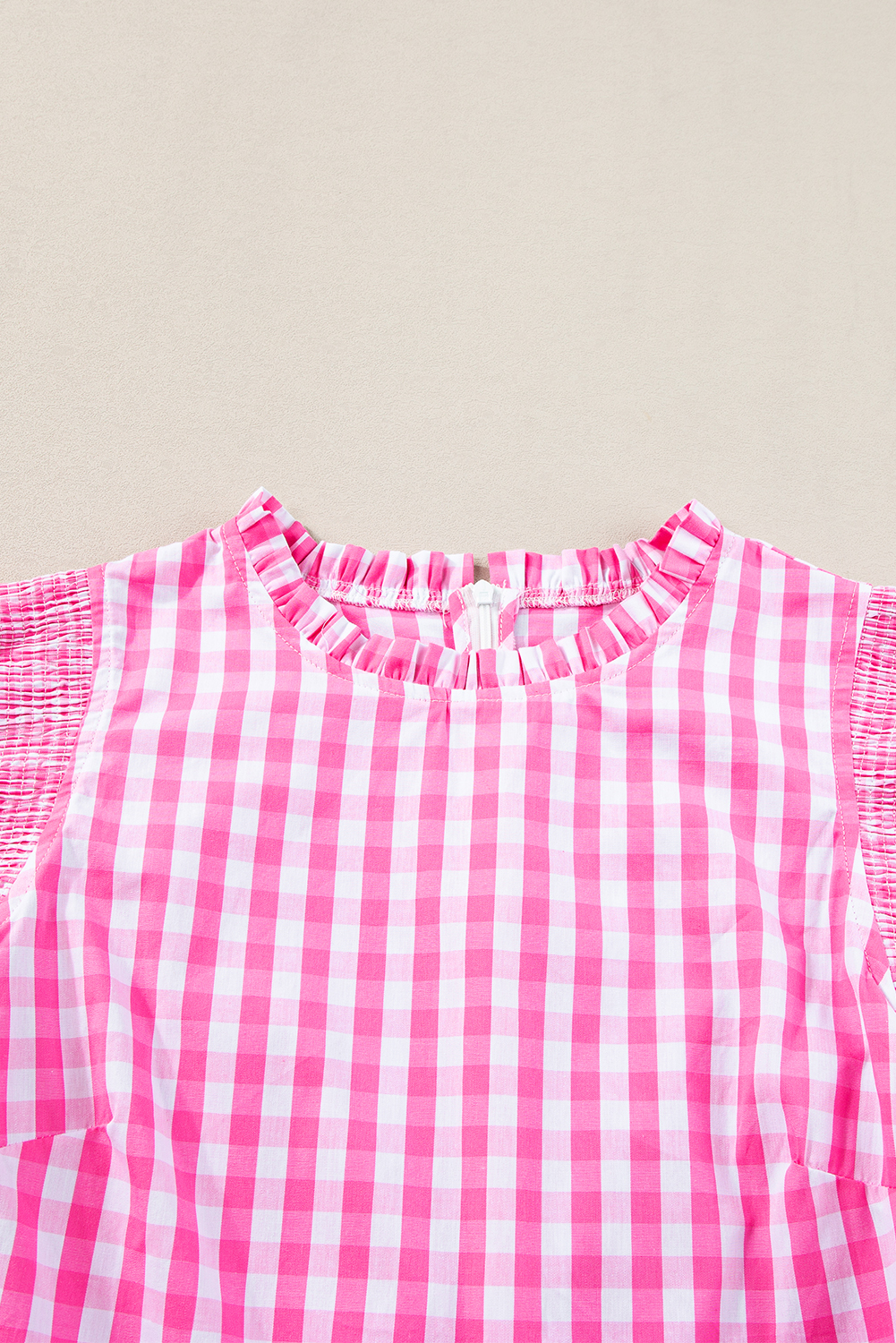 Add a touch of whimsy to your wardrobe with this Women's Rose Red Checkered Ruffled Sleeve Frilled Neck Blouse. The charming plaid print and delightful ruffled sleeves give this blouse a playful and feminine touch. The frilled neck adds a romantic charm to the overall design, making it perfect for those seeking a stylish and elegant look. This blouse is ideal for various occasions, from casual wear with jeans or shorts to dressier settings. With its lightweight and breathable 100% cotton fabric, this blouse ensures comfort and durability. The elegant design and trendy styling make it a must-have piece for your wardrobe. - Detail View 9 Add a touch of whimsy to your wardrobe with this Women's Rose Red Checkered Ruffled Sleeve Frilled Neck Blouse. The charming plaid print and delightful ruffled sleeves give this blouse a playful and feminine touch. The frilled neck adds a romantic charm to the overall design, making it perfect for those seeking a stylish and elegant look. This blouse is ideal for various occasions, from casual wear with jeans or shorts to dressier settings. With its lightweight and breathable 100% cotton fabric, this blouse ensures comfort and durability. The elegant design and trendy styling make it a must-have piece for your wardrobe. - Detail View 9
