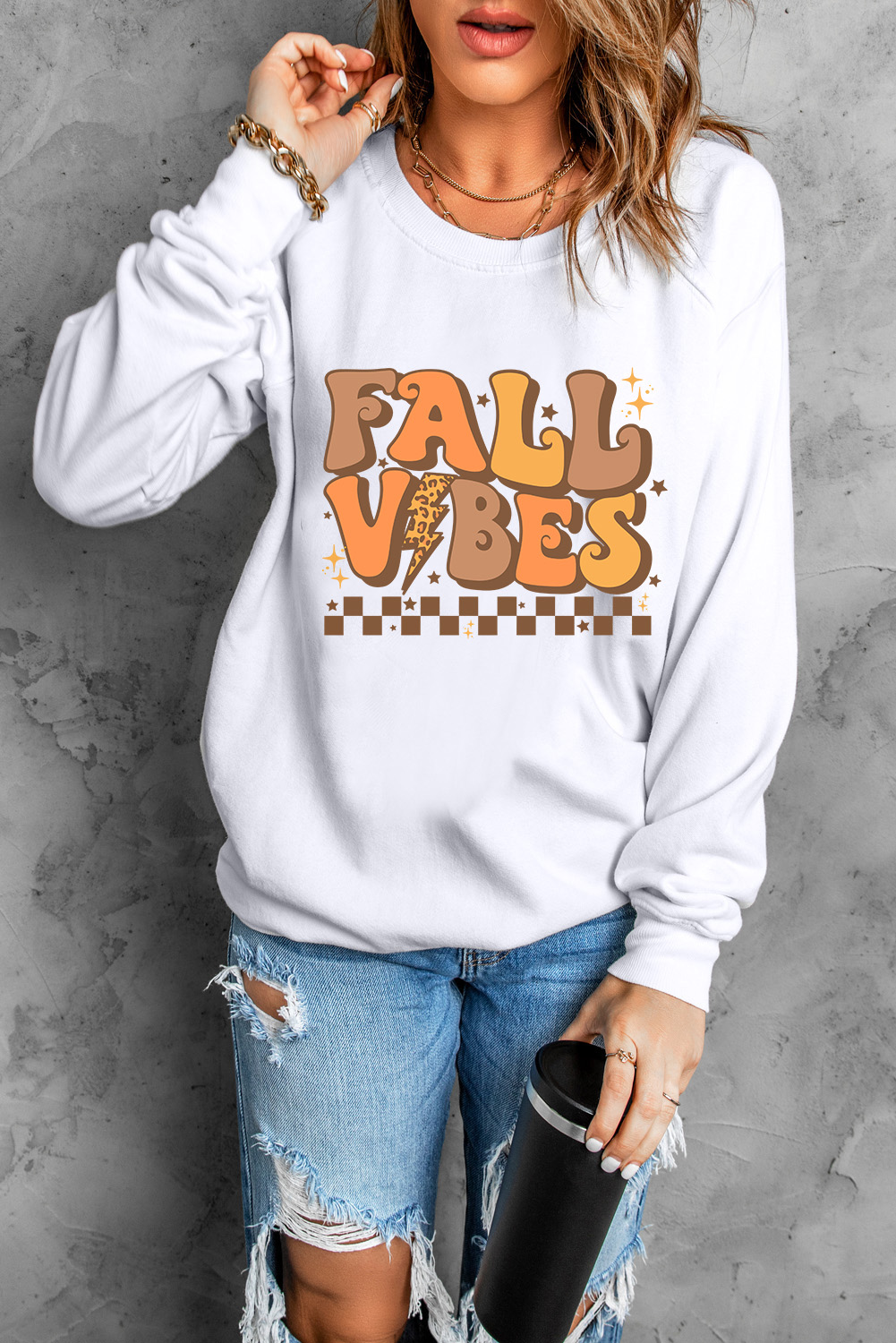Embrace the autumn season in style and comfort with this Women's Beige Fall Vibes Graphic Drop Shoulder Sweatshirt. The relaxed silhouette, featuring drop shoulders and a crew neck, provides a comfortable and laid-back look, perfect for casual wear. The 'FALL VIBES' graphic on the sweatshirt captures the essence of fall, adding a touch of seasonal charm to your outfit. Made from a premium blend of 50% polyester and 50% cotton, this sweatshirt ensures both durability and softness for all-day comfort. Pair it with your favorite jeans or leggings for a chic and trendy attire to truly enjoy the fall vibes. This graphic sweatshirt is ideal for layering on cooler days, adding both style and warmth to your fall wardrobe. - Detail View 4 Embrace the autumn season in style and comfort with this Women's Beige Fall Vibes Graphic Drop Shoulder Sweatshirt. The relaxed silhouette, featuring drop shoulders and a crew neck, provides a comfortable and laid-back look, perfect for casual wear. The 'FALL VIBES' graphic on the sweatshirt captures the essence of fall, adding a touch of seasonal charm to your outfit. Made from a premium blend of 50% polyester and 50% cotton, this sweatshirt ensures both durability and softness for all-day comfort. Pair it with your favorite jeans or leggings for a chic and trendy attire to truly enjoy the fall vibes. This graphic sweatshirt is ideal for layering on cooler days, adding both style and warmth to your fall wardrobe. - Detail View 4