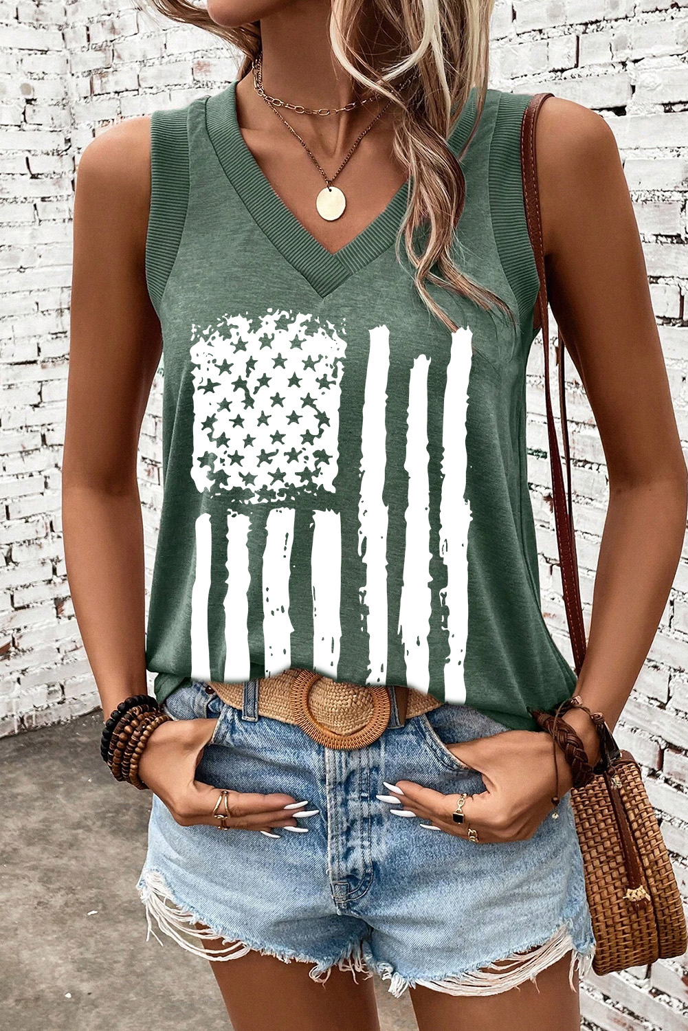 Show off your American pride in style with this Mist Green Frayed American Flag Printed V Neck Tank Top. The vintage distressed design adds a touch of rugged Americana charm, making it a unique and eye-catching piece for any occasion. The V neck cut provides a flattering and relaxed fit, while the soft and breathable fabric ensures all-day comfort. This graphic tank top is perfect for casual summer days, outdoor gatherings, or everyday wear. Pair it with jeans, shorts, or a flowy skirt for a chic and playful ensemble. Crafted from a premium blend of polyester, viscose, and elastane, this tank top is soft, comfortable, and durable. Let your personality shine through with this fashionable and patriotic top. - Detail View 4 Show off your American pride in style with this Mist Green Frayed American Flag Printed V Neck Tank Top. The vintage distressed design adds a touch of rugged Americana charm, making it a unique and eye-catching piece for any occasion. The V neck cut provides a flattering and relaxed fit, while the soft and breathable fabric ensures all-day comfort. This graphic tank top is perfect for casual summer days, outdoor gatherings, or everyday wear. Pair it with jeans, shorts, or a flowy skirt for a chic and playful ensemble. Crafted from a premium blend of polyester, viscose, and elastane, this tank top is soft, comfortable, and durable. Let your personality shine through with this fashionable and patriotic top. - Detail View 4
