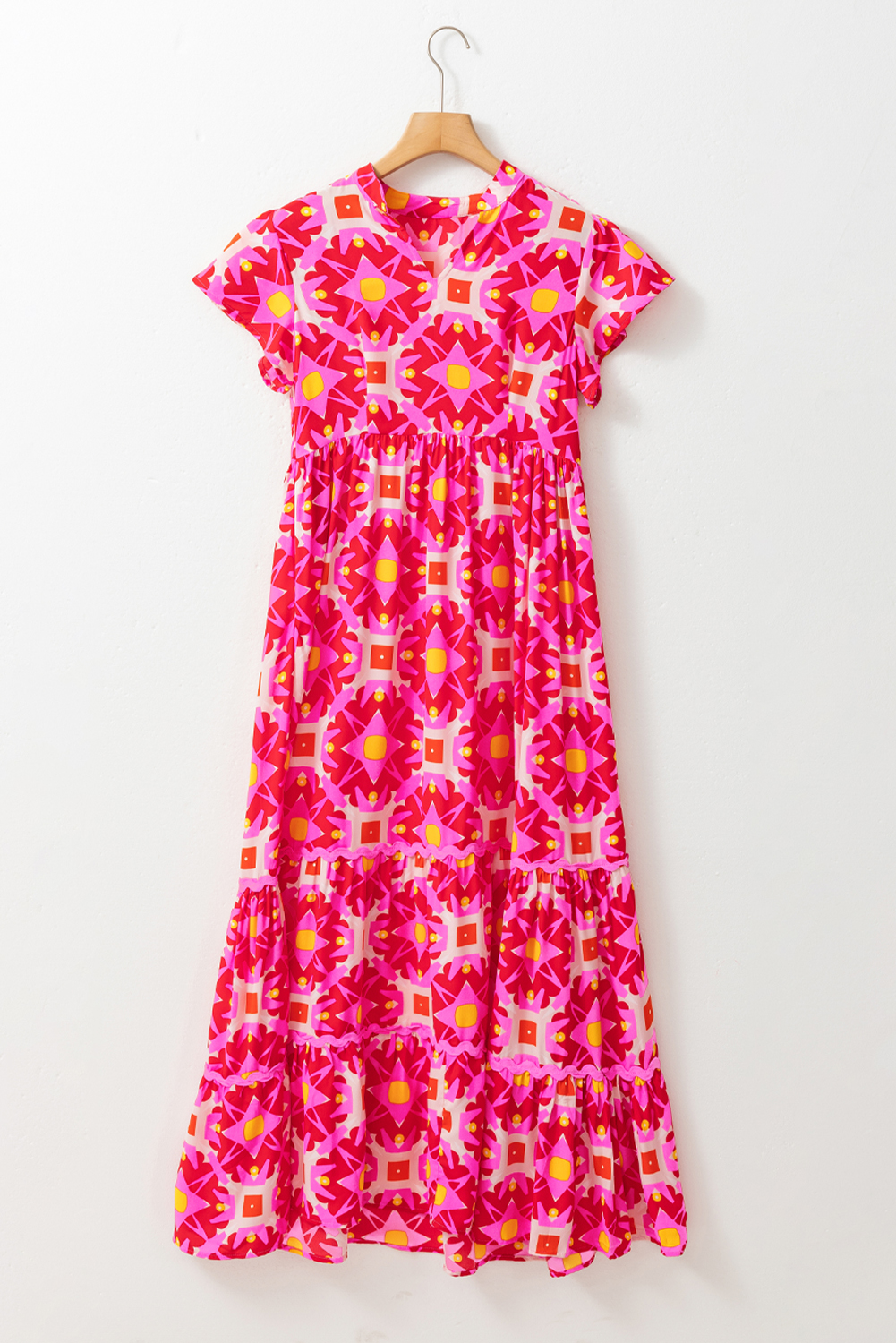 Make a statement with this vibrant Strawberry Pink Geo Print V-Neck Maxi Dress. Crafted from soft and breathable fabric, this dress features a unique and eye-catching abstract geo print that's sure to turn heads. The short sleeve design is perfect for warm weather, while the maxi length is flattering and stylish. The V-neckline adds a touch of sophistication to the overall design. This casual and comfortable dress is perfect for daily wear or a vacation look. The A-line silhouette and natural waistline create a beautiful curves, while the zipper details add a touch of femininity. Pair it with sandals or sneakers for a chic and trendy outfit. - Detail View 4 Make a statement with this vibrant Strawberry Pink Geo Print V-Neck Maxi Dress. Crafted from soft and breathable fabric, this dress features a unique and eye-catching abstract geo print that's sure to turn heads. The short sleeve design is perfect for warm weather, while the maxi length is flattering and stylish. The V-neckline adds a touch of sophistication to the overall design. This casual and comfortable dress is perfect for daily wear or a vacation look. The A-line silhouette and natural waistline create a beautiful curves, while the zipper details add a touch of femininity. Pair it with sandals or sneakers for a chic and trendy outfit. - Detail View 4
