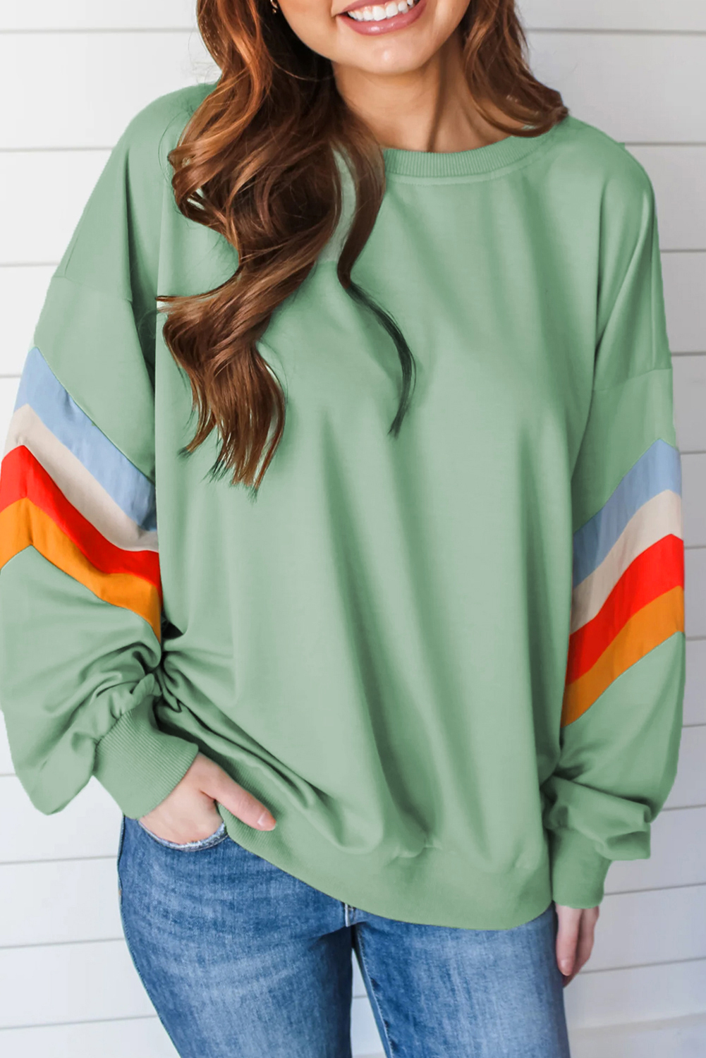 Add a pop of color to your casual wear with this Women's Moonlight Jade Rainbow Striped Sleeve Crew Neck Loose Fit Sweatshirt. The vibrant rainbow stripes create a striking visual effect, while the crew neck design ensures a classic and timeless look. The drop shoulder design adds a relaxed and slouchy vibe to the sweatshirt, making it perfect for everyday wear. The loose fit allows for a comfortable fit on different body shapes. Made from a soft blend of 65% polyester and 35% cotton, this sweatshirt is designed to keep you cozy and warm all day long. The colorblock design adds a touch of elegance to the overall look, making it suitable for both casual and dressy occasions. Explore a vast selection of trendy designs and find the perfect sweatshirt for your unique style. - Detail View 4 Add a pop of color to your casual wear with this Women's Moonlight Jade Rainbow Striped Sleeve Crew Neck Loose Fit Sweatshirt. The vibrant rainbow stripes create a striking visual effect, while the crew neck design ensures a classic and timeless look. The drop shoulder design adds a relaxed and slouchy vibe to the sweatshirt, making it perfect for everyday wear. The loose fit allows for a comfortable fit on different body shapes. Made from a soft blend of 65% polyester and 35% cotton, this sweatshirt is designed to keep you cozy and warm all day long. The colorblock design adds a touch of elegance to the overall look, making it suitable for both casual and dressy occasions. Explore a vast selection of trendy designs and find the perfect sweatshirt for your unique style. - Detail View 4