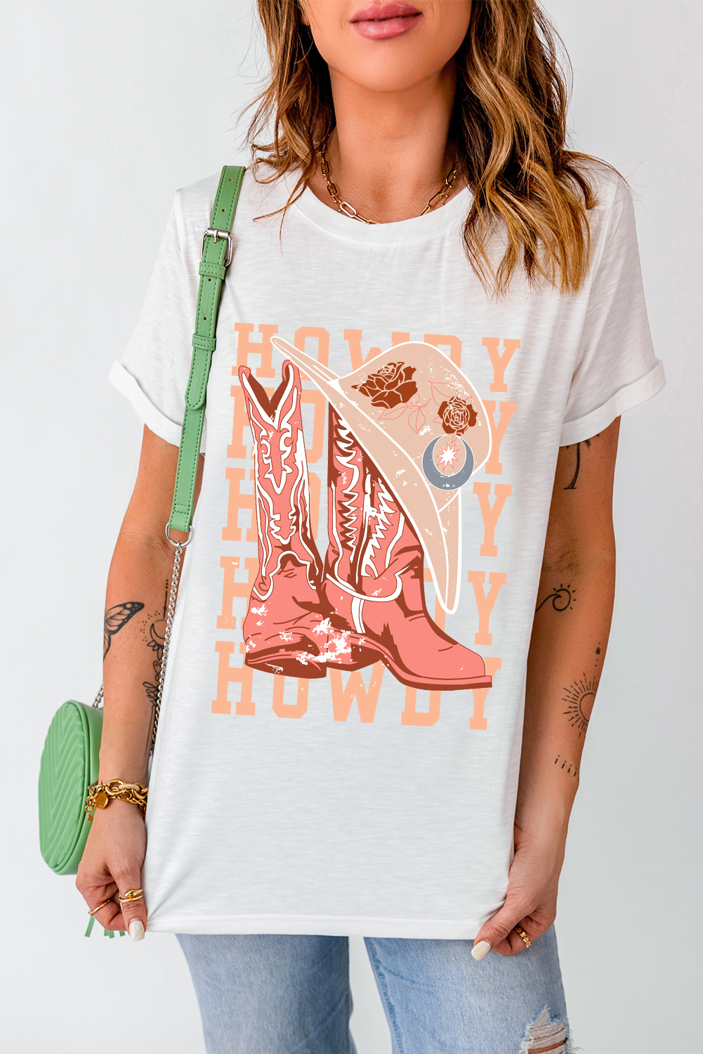 Make a statement with this eye-catching Women's White HOWDY Cowboy Boots Graphic Crew Neck T-Shirt. The Western-inspired vibe is evident with the stylish boots letter design that adds a playful touch to the graphic. The HOWDY lettering stands out, creating a trendy and statement-making look. The short sleeves ensure comfortable and casual wear, perfect for daily styling. Made from a blend of 62% polyester, 32% cotton, and 6% elastane, this t-shirt offers a comfortable fit and versatility in styles. The graphic design adds a playful and fashionable element to your wardrobe, making it a must-have for a trendy update. Pair it with your favorite jeans or shorts for a chic and casual ensemble. - Detail View 4 Make a statement with this eye-catching Women's White HOWDY Cowboy Boots Graphic Crew Neck T-Shirt. The Western-inspired vibe is evident with the stylish boots letter design that adds a playful touch to the graphic. The HOWDY lettering stands out, creating a trendy and statement-making look. The short sleeves ensure comfortable and casual wear, perfect for daily styling. Made from a blend of 62% polyester, 32% cotton, and 6% elastane, this t-shirt offers a comfortable fit and versatility in styles. The graphic design adds a playful and fashionable element to your wardrobe, making it a must-have for a trendy update. Pair it with your favorite jeans or shorts for a chic and casual ensemble. - Detail View 4