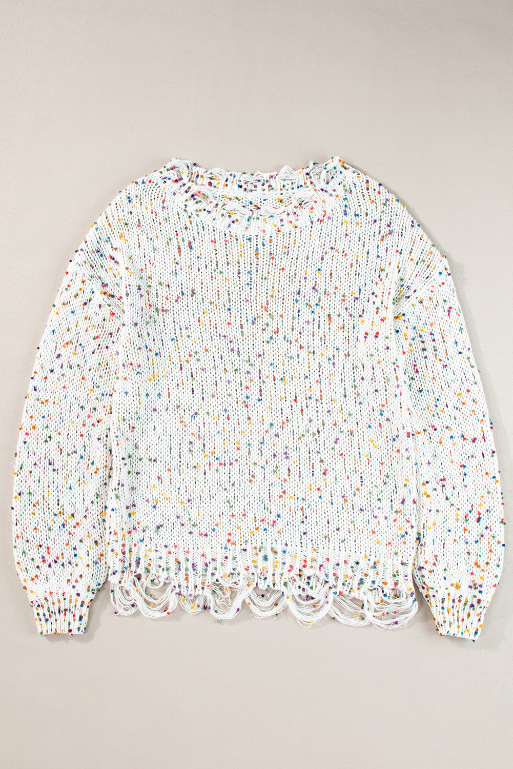 Slay all season long in our Women's White Colorful Confetti Distressed Knit Sweater. This stylish sweater features a colorful confetti knit silhouette with ribbed texturing, adding a playful and trendy touch to your winter wardrobe. The rounded neckline can be worn off one shoulder for a chic and fashionable look. The relaxed silhouette falls into an uneven hemline with distressed detailing, giving it a unique and edgy vibe. Made from premium 100% polyester, this sweater ensures warmth and comfort during the colder months. The multicolor damain print pattern adds a pop of color and personality to your outfit. Pair this sweater with distressed ankle skinnies for a trendy and casual ensemble that will turn heads. Embrace the winter season in style with this fashionable and comfortable sweater. - Detail View 4 Slay all season long in our Women's White Colorful Confetti Distressed Knit Sweater. This stylish sweater features a colorful confetti knit silhouette with ribbed texturing, adding a playful and trendy touch to your winter wardrobe. The rounded neckline can be worn off one shoulder for a chic and fashionable look. The relaxed silhouette falls into an uneven hemline with distressed detailing, giving it a unique and edgy vibe. Made from premium 100% polyester, this sweater ensures warmth and comfort during the colder months. The multicolor damain print pattern adds a pop of color and personality to your outfit. Pair this sweater with distressed ankle skinnies for a trendy and casual ensemble that will turn heads. Embrace the winter season in style with this fashionable and comfortable sweater. - Detail View 4