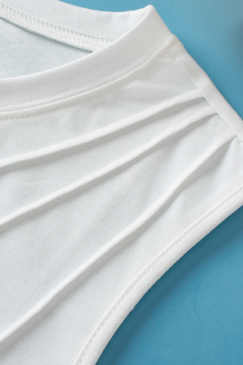 Elevate your wardrobe with this stylish and comfortable Women's White Pleated Sleeveless Crew Neck Tank Top. The pleated design adds a trendy touch to this classic sleeveless top, making it a versatile piece for any occasion. Crafted from a soft and breathable blend of 62% polyester, 32% cotton, and 6% elastane, this tank ensures all-day comfort. The crew neck offers a classic and timeless look that can be dressed up or down effortlessly. Whether worn alone or layered under a jacket or cardigan, this tank top is a flattering fit with a chic casual silhouette. Add this best-selling top to your collection for a modern and fashionable wardrobe essential. - Detail View 9 Elevate your wardrobe with this stylish and comfortable Women's White Pleated Sleeveless Crew Neck Tank Top. The pleated design adds a trendy touch to this classic sleeveless top, making it a versatile piece for any occasion. Crafted from a soft and breathable blend of 62% polyester, 32% cotton, and 6% elastane, this tank ensures all-day comfort. The crew neck offers a classic and timeless look that can be dressed up or down effortlessly. Whether worn alone or layered under a jacket or cardigan, this tank top is a flattering fit with a chic casual silhouette. Add this best-selling top to your collection for a modern and fashionable wardrobe essential. - Detail View 9
