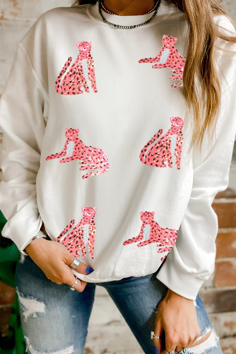 Elevate your casual style with this Women's Beige Sequin Cheetah O Neck Drop Shoulder Sweatshirt. Blending comfort with a touch of the wild side, this sweatshirt features an O neck and dropped shoulders that offer a sleek and modern silhouette. The striking cheetah patterns with shiny sequins ensure you stand out in any setting, making it an ideal choice for a statement-making outfit. Made from a blend of 50% polyester and 50% cotton, this sweatshirt provides both comfort and durability. The beige color adds a versatile and chic touch to the overall look. Perfect for the fall and autumn seasons, this sweatshirt is a must-have addition to your wardrobe. Pair it with jeans or leggings for a trendy and fashionable ensemble. Explore various styles with graphic sweatshirts to update your fashion and showcase your unique style. - Detail View 4 Elevate your casual style with this Women's Beige Sequin Cheetah O Neck Drop Shoulder Sweatshirt. Blending comfort with a touch of the wild side, this sweatshirt features an O neck and dropped shoulders that offer a sleek and modern silhouette. The striking cheetah patterns with shiny sequins ensure you stand out in any setting, making it an ideal choice for a statement-making outfit. Made from a blend of 50% polyester and 50% cotton, this sweatshirt provides both comfort and durability. The beige color adds a versatile and chic touch to the overall look. Perfect for the fall and autumn seasons, this sweatshirt is a must-have addition to your wardrobe. Pair it with jeans or leggings for a trendy and fashionable ensemble. Explore various styles with graphic sweatshirts to update your fashion and showcase your unique style. - Detail View 4