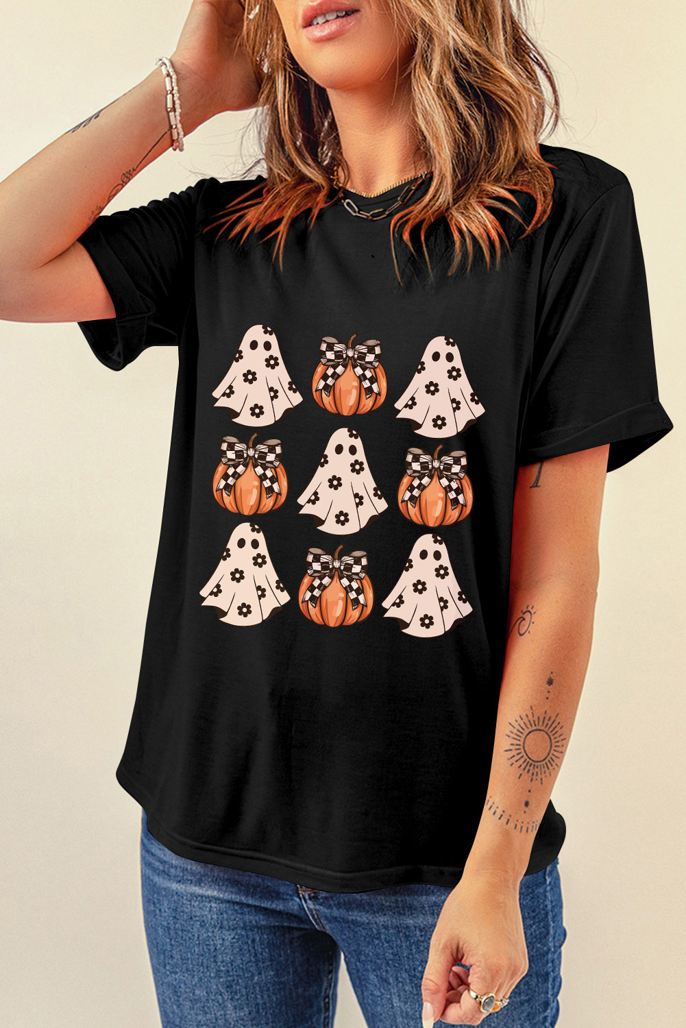 Embrace the spooky season with this Women's Black Halloween Ghost Pumpkin Print Crew Neck T-Shirt. Stand out with the playful pumpkin pattern, adding a festive touch to your Halloween attire. The classic crew neck design ensures comfort, making it perfect for warm weather with its short sleeves for a casual and cool look. Made from a blend of 62% polyester, 32% cotton, and 6% elastane, this t-shirt offers a comfortable and breathable fit. The versatile style of this graphic tee makes it a great addition to your wardrobe for a trendy and updated look. Whether you're attending a Halloween party or simply getting into the spirit of the season, this t-shirt is a must-have for adding a touch of fun to your outfit. - Detail View 4 Embrace the spooky season with this Women's Black Halloween Ghost Pumpkin Print Crew Neck T-Shirt. Stand out with the playful pumpkin pattern, adding a festive touch to your Halloween attire. The classic crew neck design ensures comfort, making it perfect for warm weather with its short sleeves for a casual and cool look. Made from a blend of 62% polyester, 32% cotton, and 6% elastane, this t-shirt offers a comfortable and breathable fit. The versatile style of this graphic tee makes it a great addition to your wardrobe for a trendy and updated look. Whether you're attending a Halloween party or simply getting into the spirit of the season, this t-shirt is a must-have for adding a touch of fun to your outfit. - Detail View 4