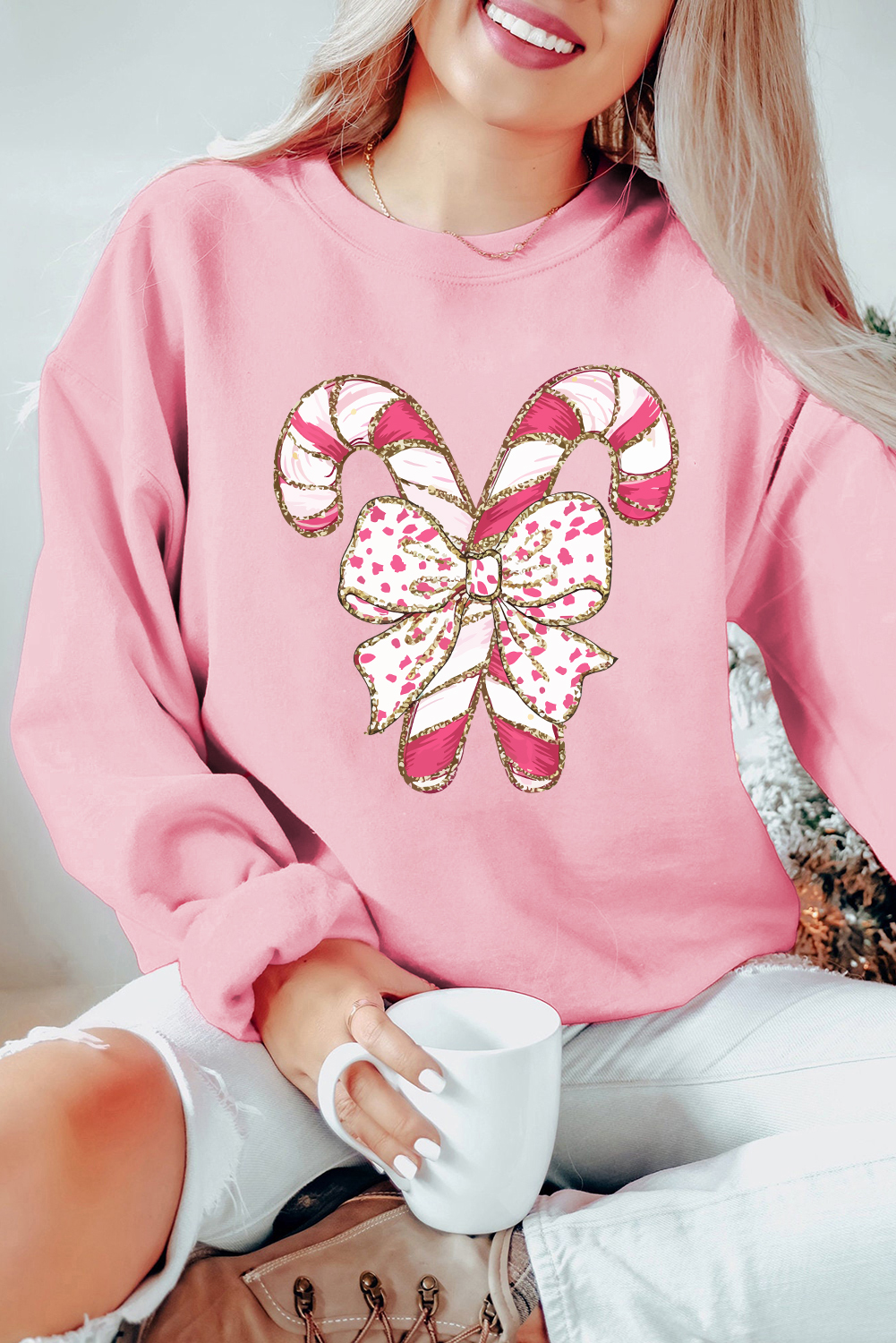 Festive Pink Sweatshirt with Candy Cane Graphics and Bow Detail - Cozy Holiday Wear - Detail View 2 Festive Pink Sweatshirt with Candy Cane Graphics and Bow Detail - Cozy Holiday Wear - Detail View 2