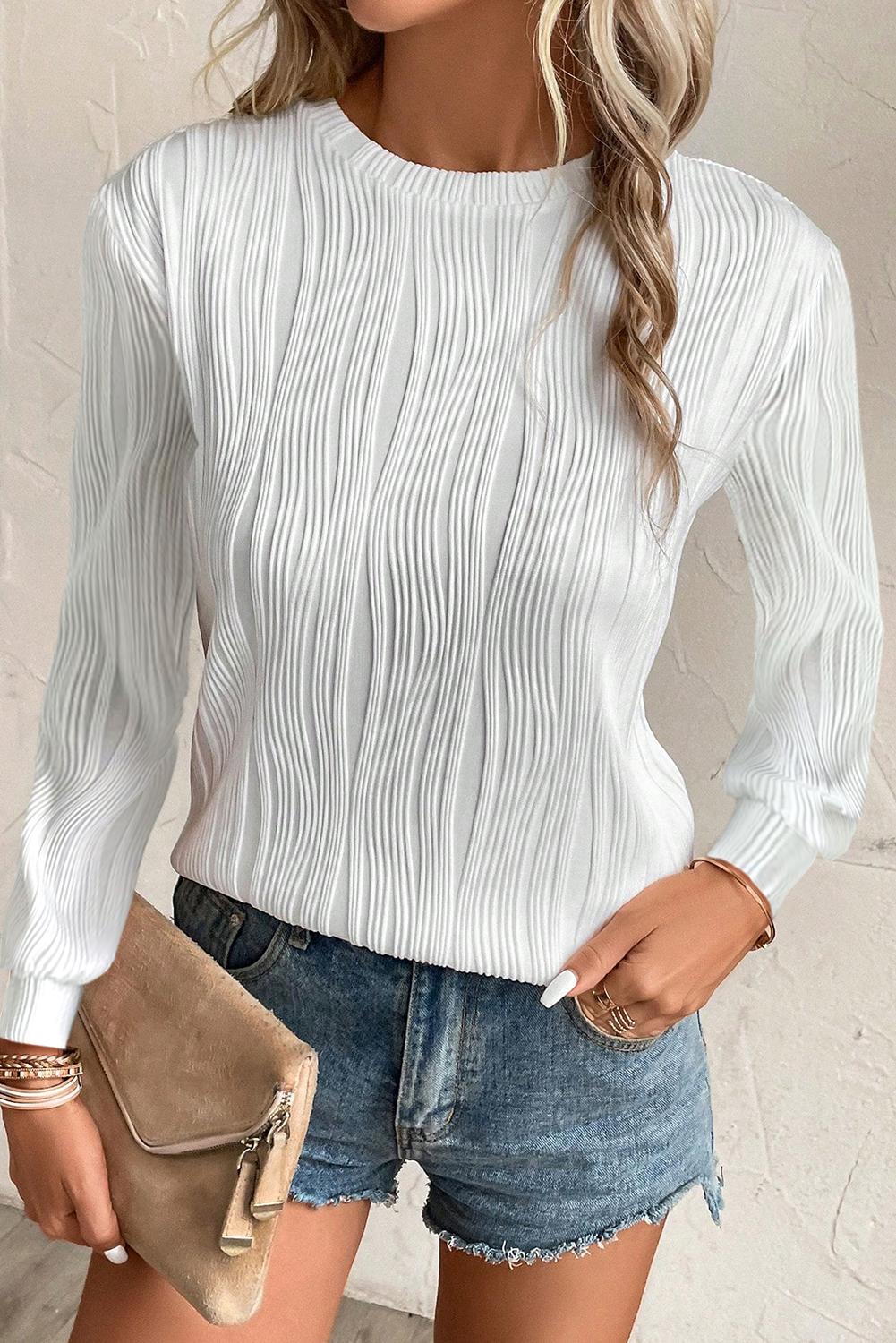 Elevate your casual wardrobe with this Women's White Textured Wavy Round Neck Long Sleeve Top. The intricate wavy fabric adds a distinctive tactile appeal, creating a unique and stylish look. The classic round neck design is suitable for most and complements any outfit. This timeless top features a concise style and solid white color, making it versatile and easy to style. Made from a premium blend of 91% polyester and 9% elastane, this top offers both comfort and durability. The long sleeves make it perfect for the fall and autumn seasons, pairing well with any fashionable jeans and pants. Whether for work or daily wear, this top is a must-have addition to your wardrobe, offering a modern and chic style. - Detail View 9 Elevate your casual wardrobe with this Women's White Textured Wavy Round Neck Long Sleeve Top. The intricate wavy fabric adds a distinctive tactile appeal, creating a unique and stylish look. The classic round neck design is suitable for most and complements any outfit. This timeless top features a concise style and solid white color, making it versatile and easy to style. Made from a premium blend of 91% polyester and 9% elastane, this top offers both comfort and durability. The long sleeves make it perfect for the fall and autumn seasons, pairing well with any fashionable jeans and pants. Whether for work or daily wear, this top is a must-have addition to your wardrobe, offering a modern and chic style. - Detail View 9