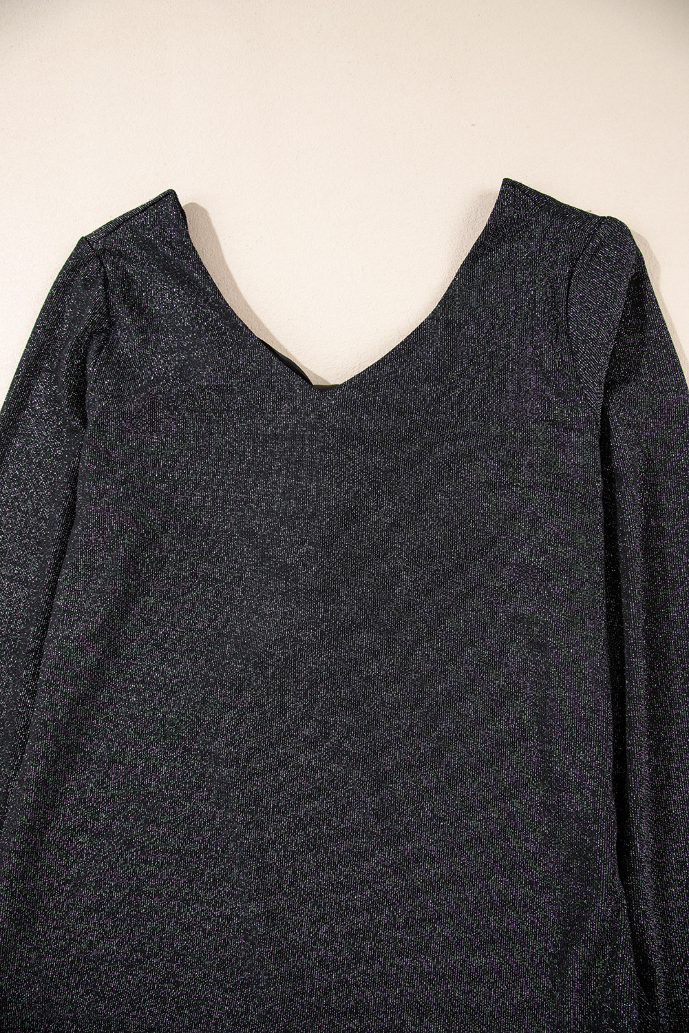 Make a statement with this stunning Women's Metallic Black Bowknot Open Back V Neck Long Sleeve Top. The dazzling metallic sheen and sweet bowknot combine for a whimsical and feminine design. The open back feature adds a subtle yet chic reveal, perfect for a back detail. The V neck design elongates the neck, providing a flattering and sophisticated look. This long sleeve top is ideal for layering and offers year-round versatility. Pair it with high-waisted pants or a flowy skirt for a chic and elegant outfit. This piece is sure to add a touch of glamour to any occasion. - Detail View 14 Make a statement with this stunning Women's Metallic Black Bowknot Open Back V Neck Long Sleeve Top. The dazzling metallic sheen and sweet bowknot combine for a whimsical and feminine design. The open back feature adds a subtle yet chic reveal, perfect for a back detail. The V neck design elongates the neck, providing a flattering and sophisticated look. This long sleeve top is ideal for layering and offers year-round versatility. Pair it with high-waisted pants or a flowy skirt for a chic and elegant outfit. This piece is sure to add a touch of glamour to any occasion. - Detail View 14
