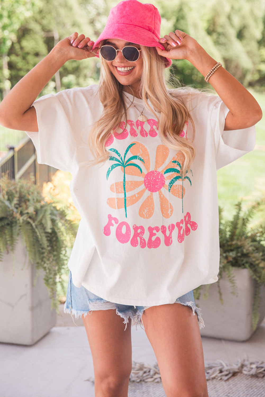 Escape to eternal summer with this White SUMMER FOREVER Flower Graphic T-Shirt for Women. This vibrant graphic tee is crafted from comfortable 95% cotton and 5% elastane fabric, perfect for warm weather wear. The crew neck and relaxed fit ensure ease of wear, while the eye-catching floral prints and Summer Forever motif celebrate the hot season. Pair this graphic tee with shorts or jeans for a summery look that's perfect for daily wear. This t-shirt is a must-have for your summer wardrobe, offering both comfort and style. - Detail View 4 Escape to eternal summer with this White SUMMER FOREVER Flower Graphic T-Shirt for Women. This vibrant graphic tee is crafted from comfortable 95% cotton and 5% elastane fabric, perfect for warm weather wear. The crew neck and relaxed fit ensure ease of wear, while the eye-catching floral prints and Summer Forever motif celebrate the hot season. Pair this graphic tee with shorts or jeans for a summery look that's perfect for daily wear. This t-shirt is a must-have for your summer wardrobe, offering both comfort and style. - Detail View 4